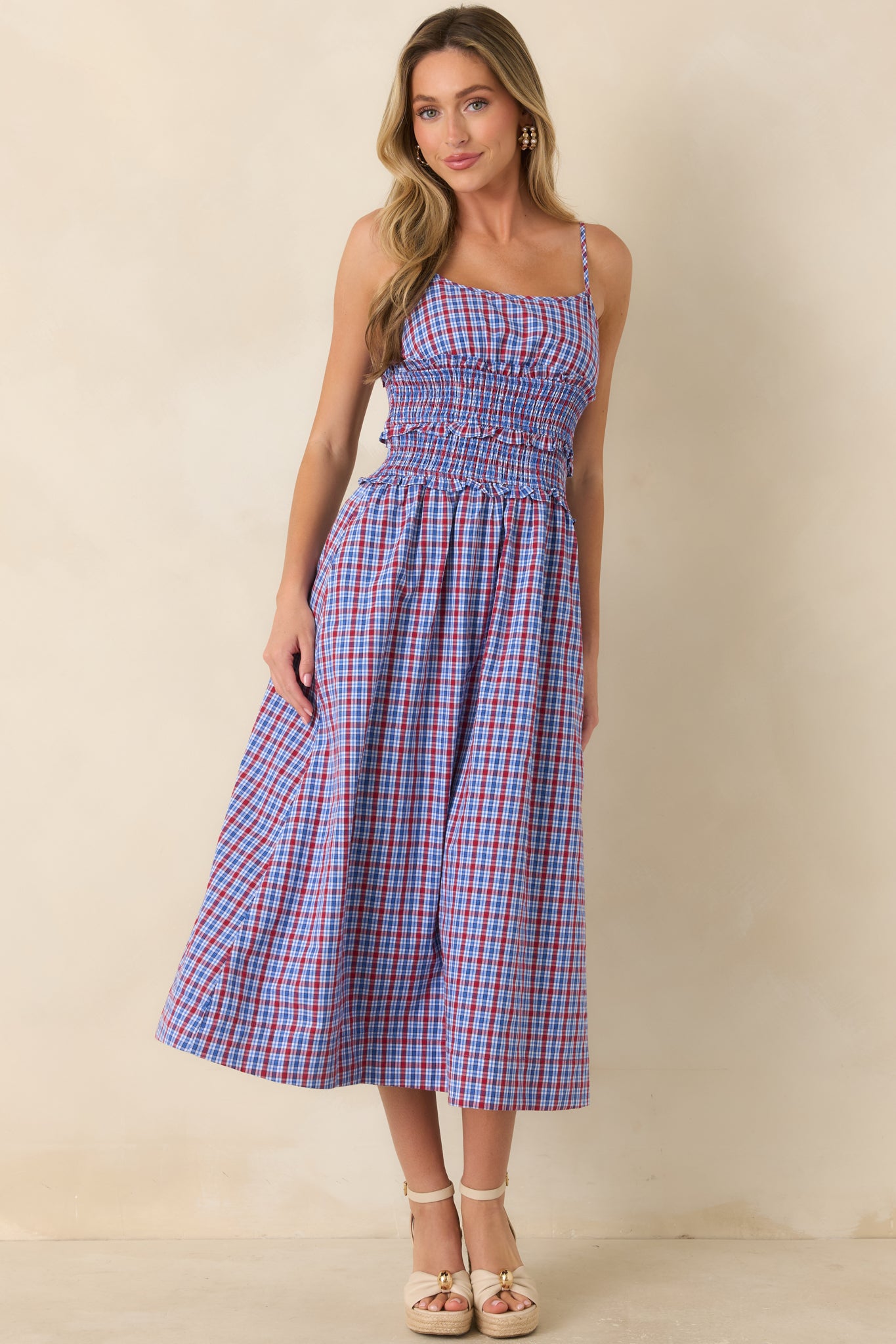 Lightweight dress with a flattering smocked bodice, adjustable straps, flowing gathered skirt, and practical side pockets.