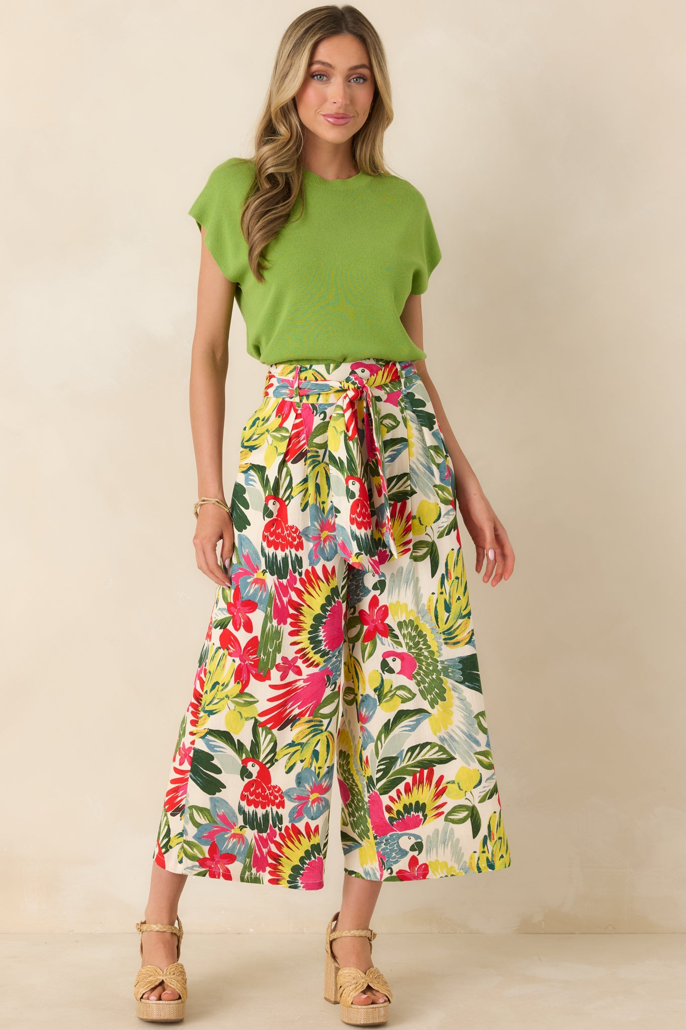 Lightweight statement pants featuring bold tropical hues, high waist with coordinating tie, and breezy wide-leg cut
