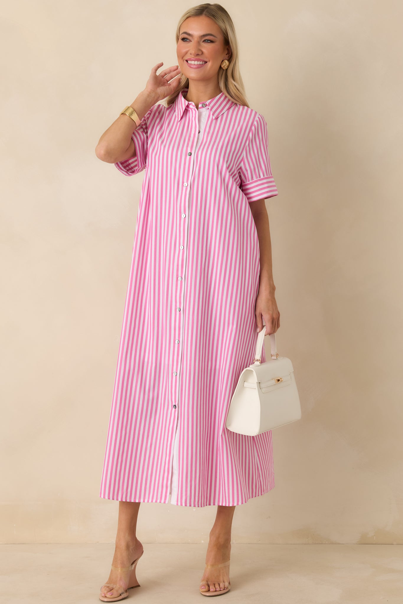 Lightweight striped dress with classic collar, full front buttons, and easy, seasonless silhouette.
