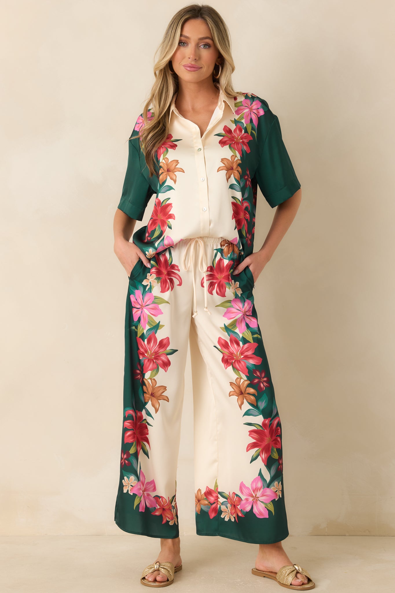 Lightweight teal satin top showcasing a silky fabric finish, short sleeves, and vibrant floral-inspired design.
