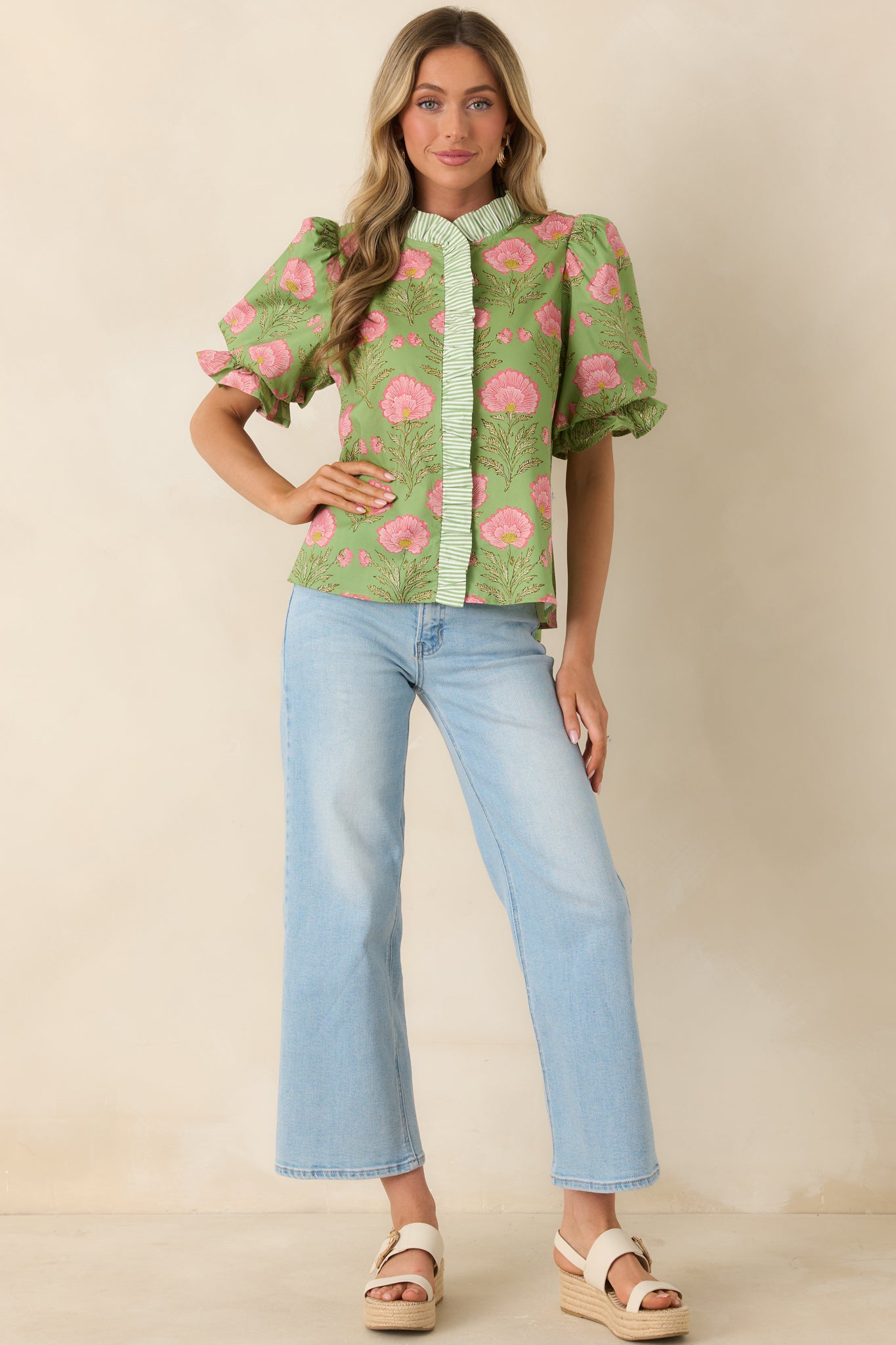 Lightweight warm-weather top featuring gathered shoulders and playful silhouette.
