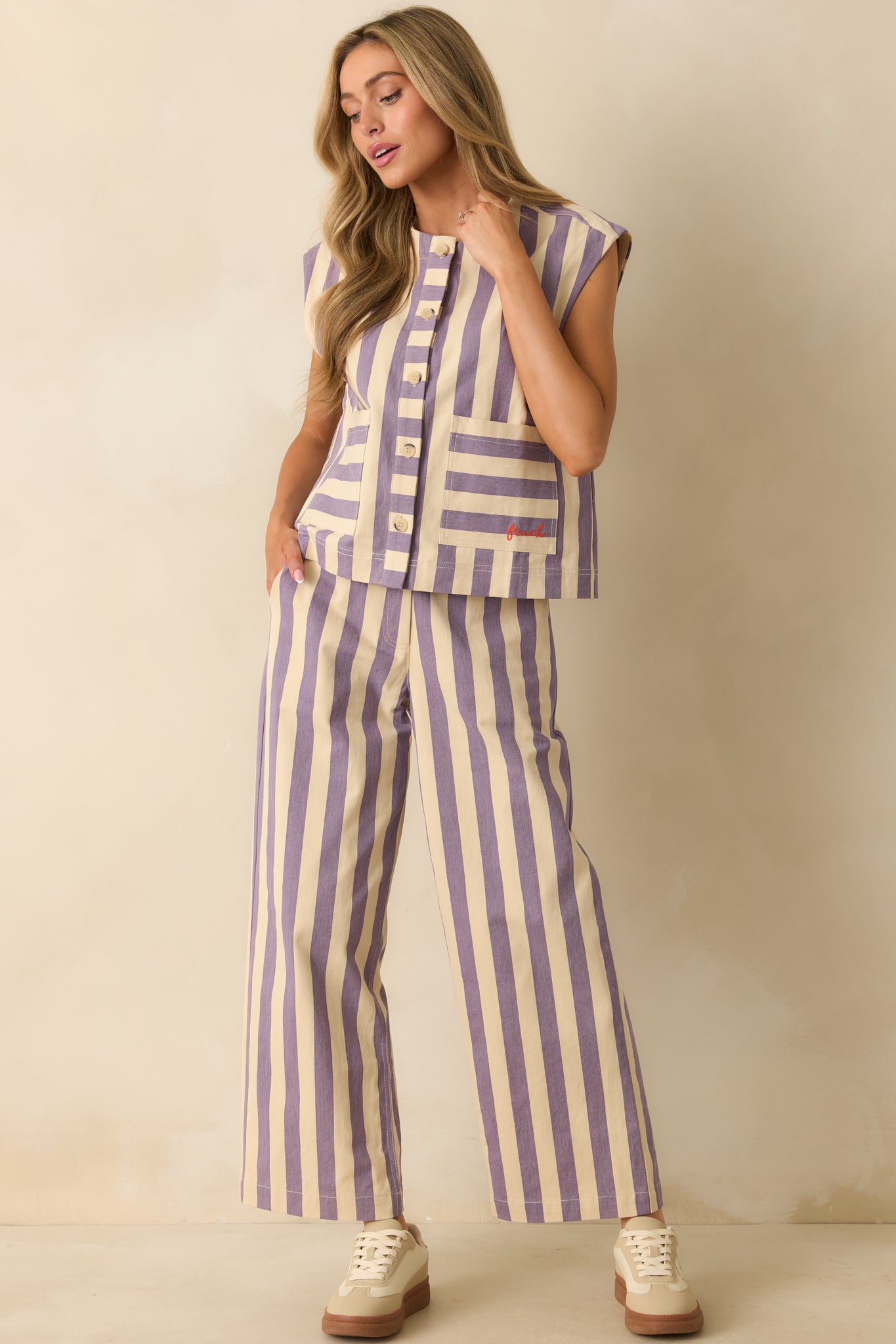 Lilac striped vest with a structured, sleeveless silhouette, front button closures, and large patch pockets.