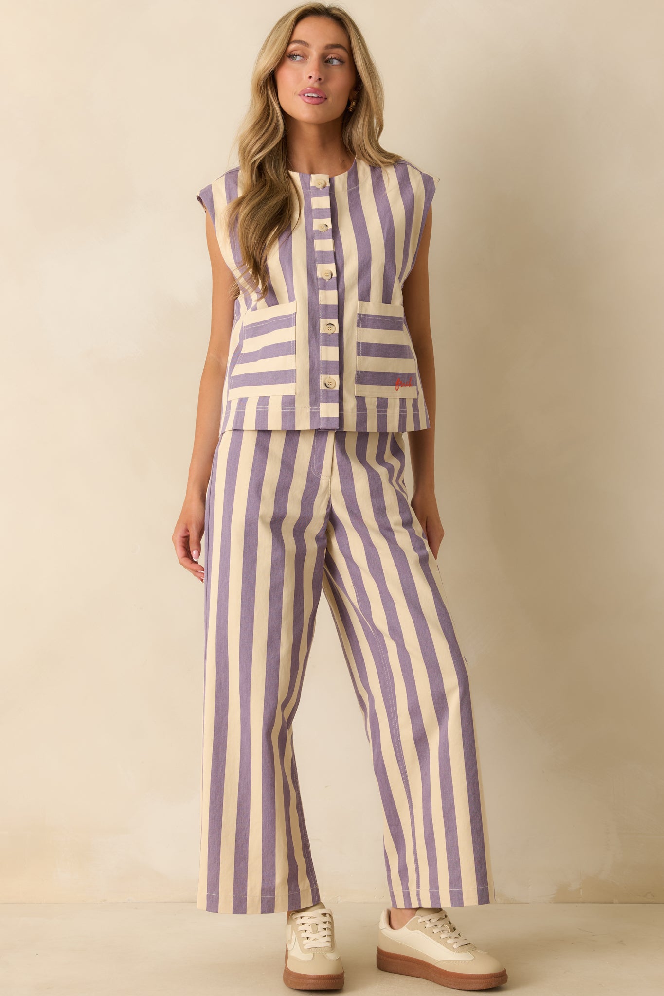 Front-facing lilac striped vest showing its crew neckline, buttoned front, and relaxed yet structured fit.