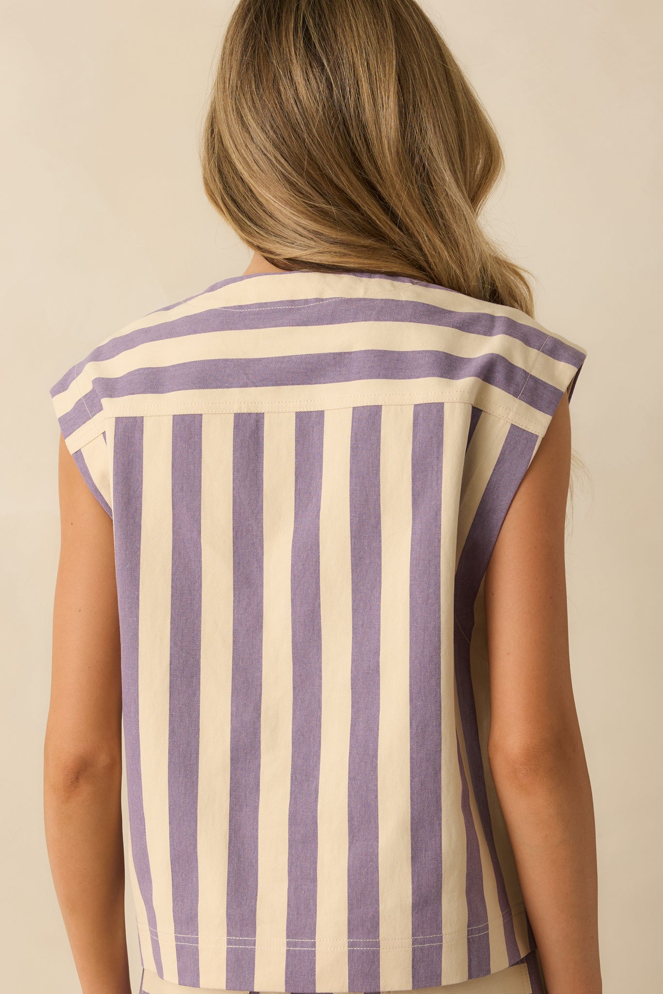 Rear view of the lilac striped vest showing its structured sleeveless silhouette and continuous vertical stripes.
