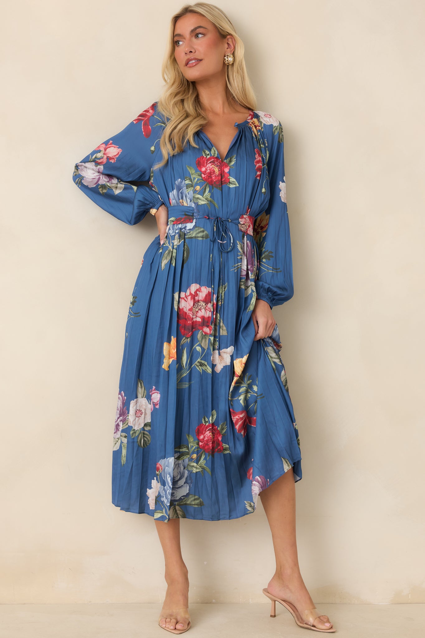 Lined blue dress with a gathered neckline, softly voluminous sleeves, and a gracefully draped midi skirt.