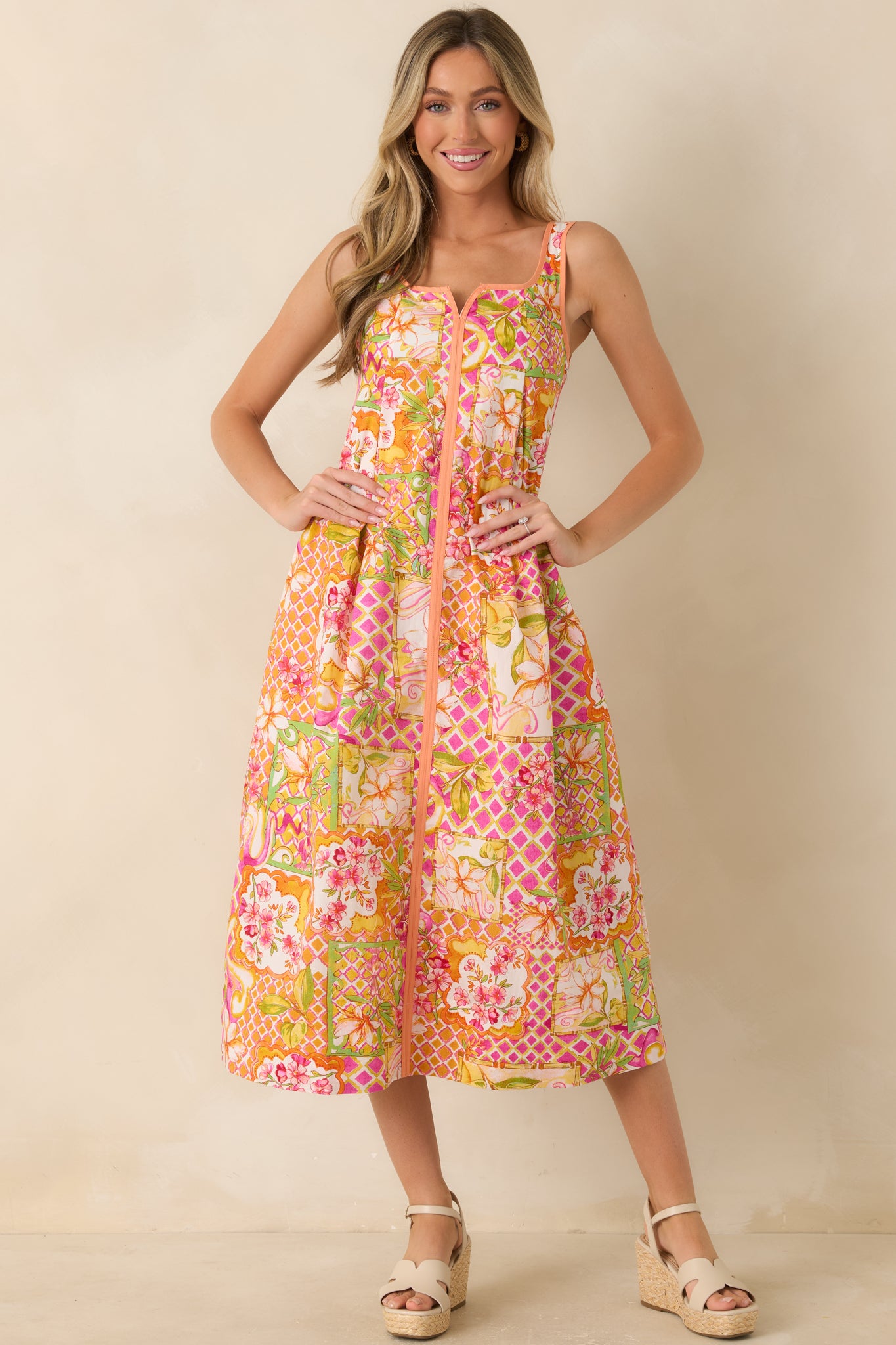Fully lined cotton midi dress showcasing a vibrant floral print, notched square neckline, and an easy, feminine silhouette.