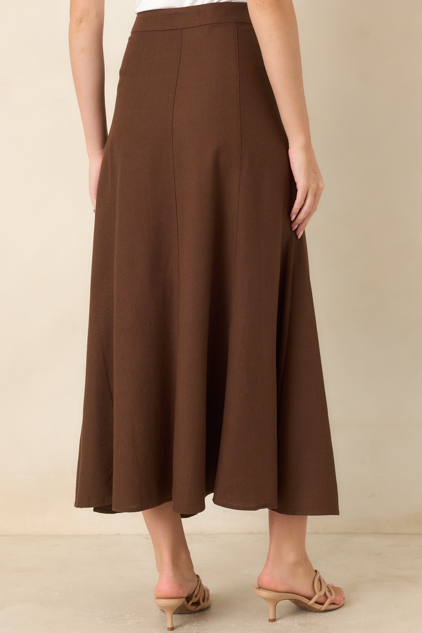 Rear view of the linen and cotton blend skirt featuring a clean high-rise waistband, smooth back panels, and a flowing A-line silhouette.