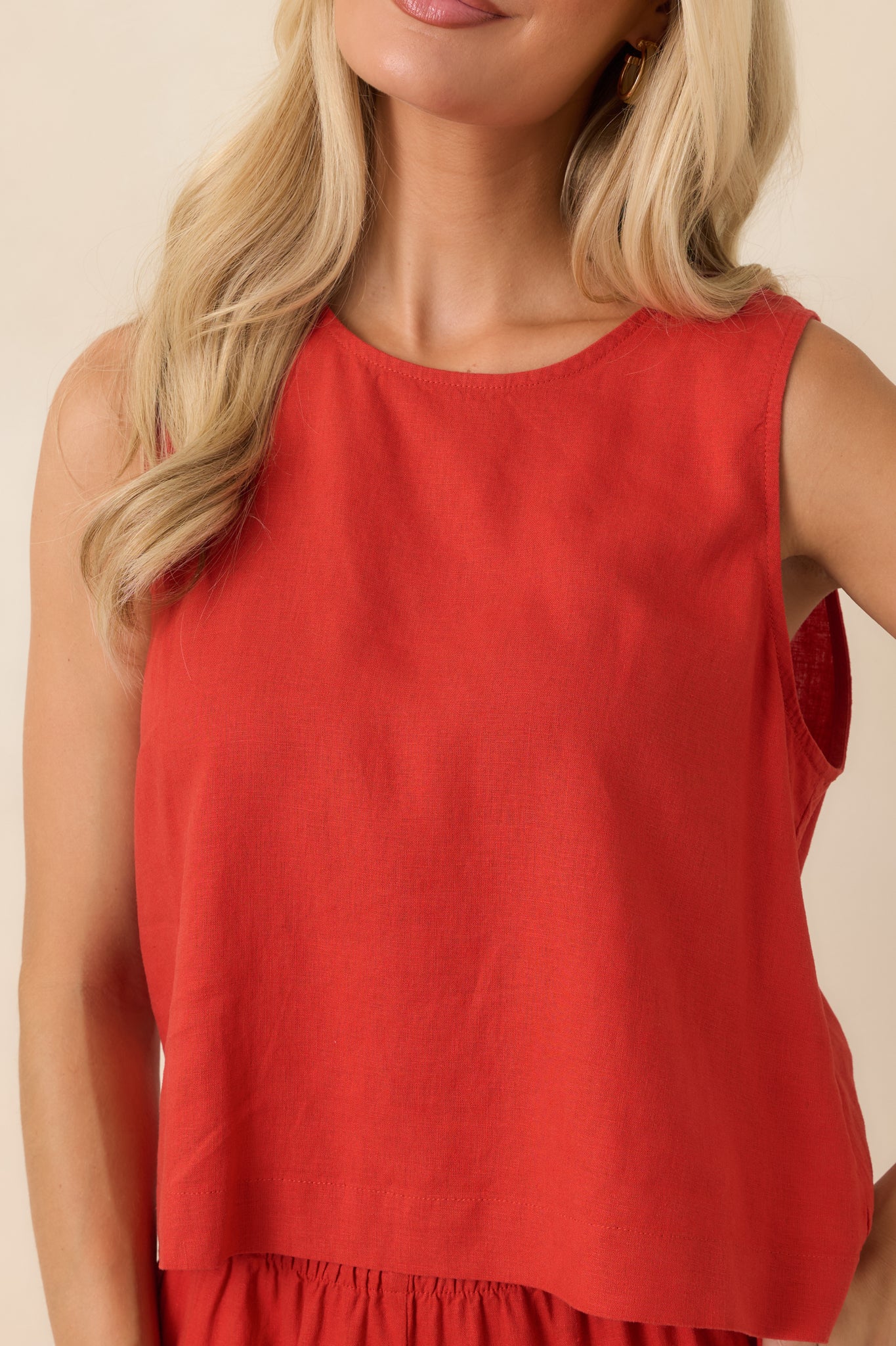 Close-up detail of the linen blend fabric, round neckline, and vibrant chili pepper red hue.