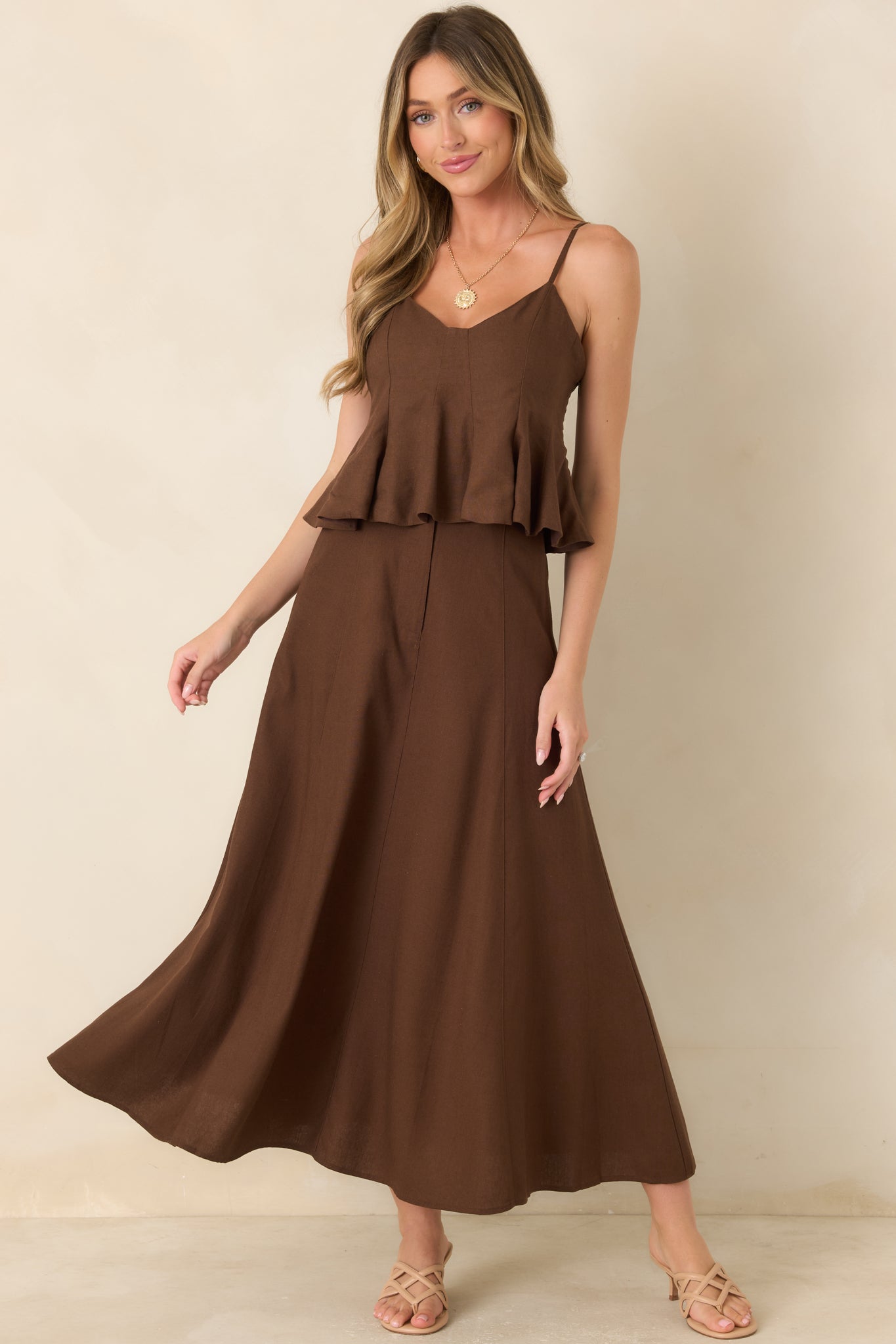Linen and cotton blend skirt featuring a structured high-rise waistband, concealed zip-front closure, coordinating waist button, and sweeping A-line silhouette.