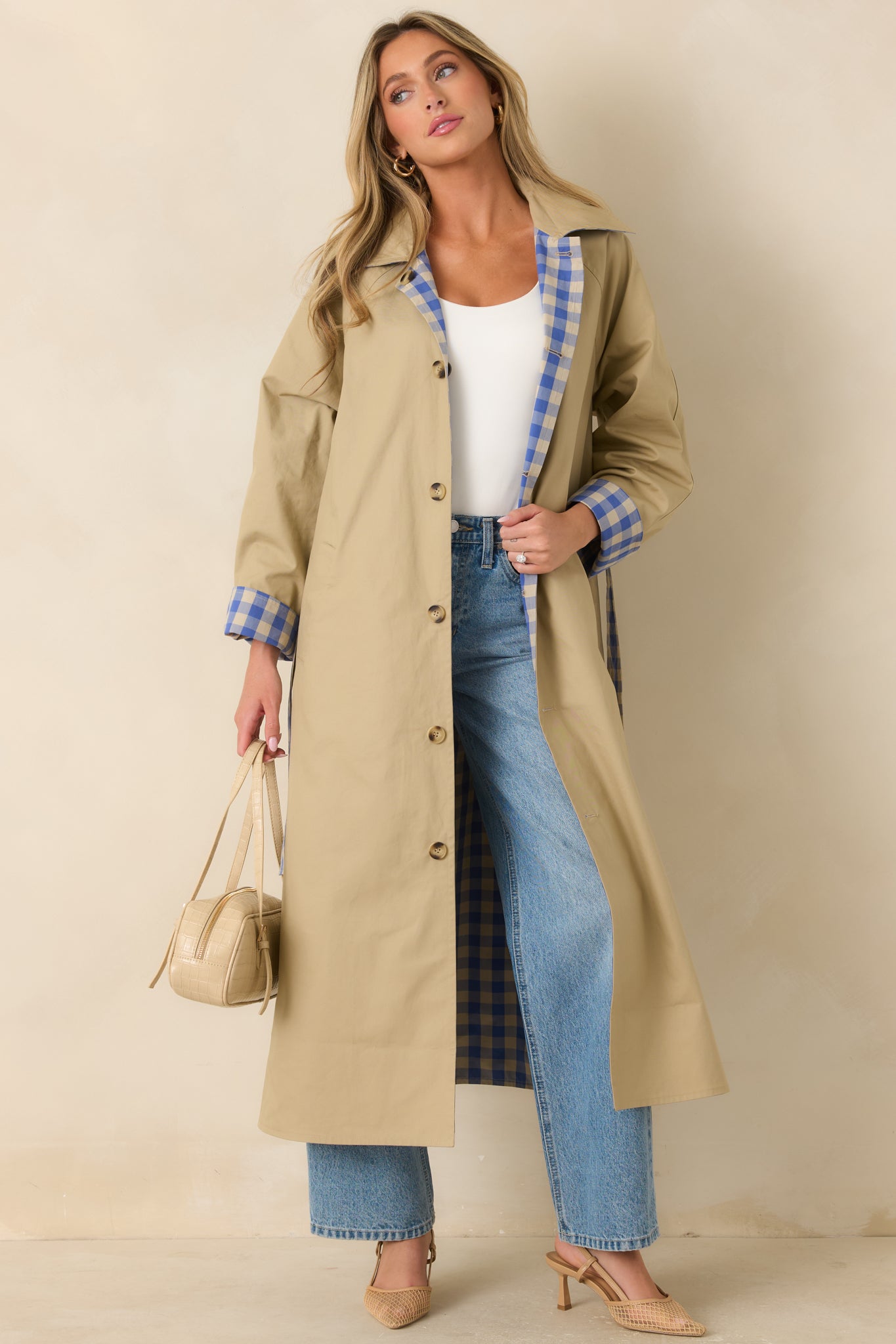 Long reversible cotton coat with a relaxed silhouette, removable tie belt, full-length buttons, and contrasting collar for versatile styling.