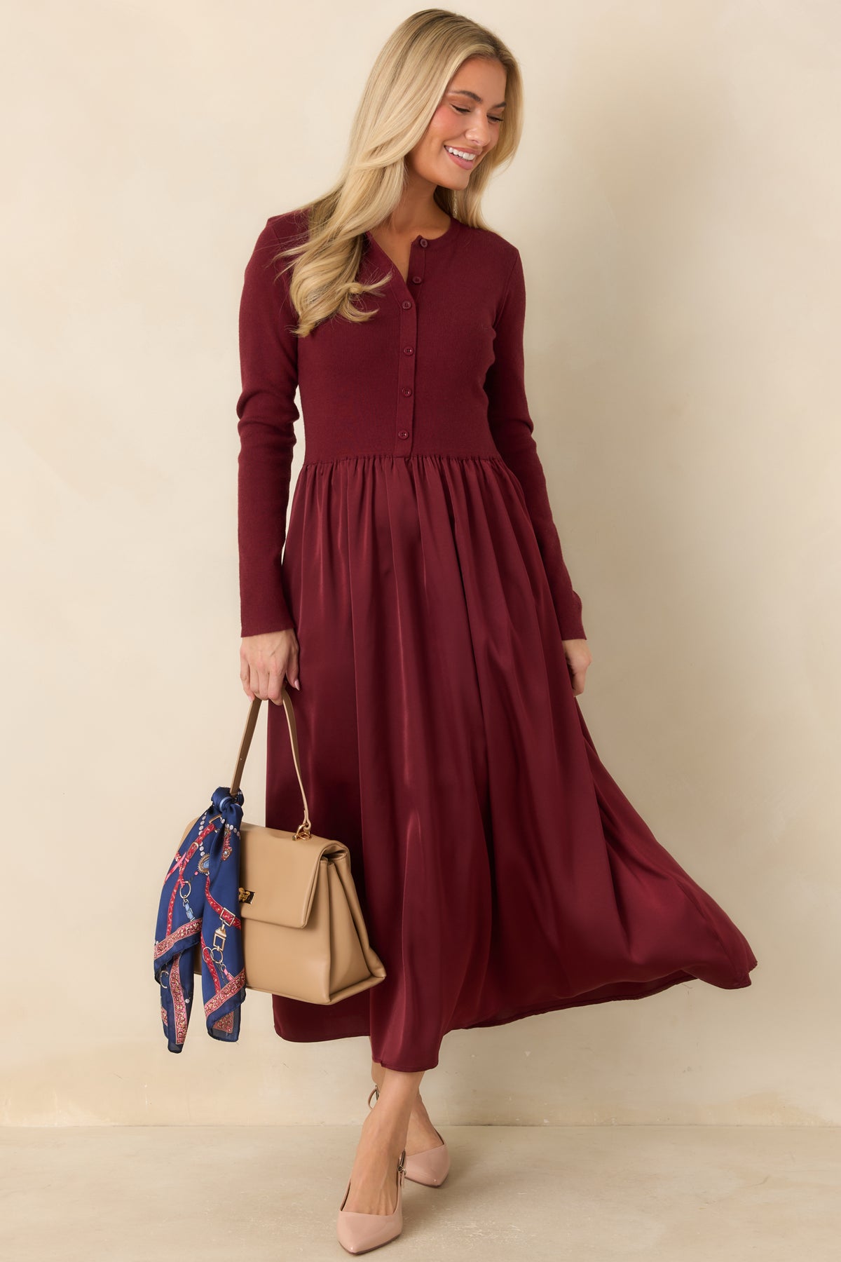 Long-sleeve cardigan dress with tonal buttons and a flowing satin midi skirt.