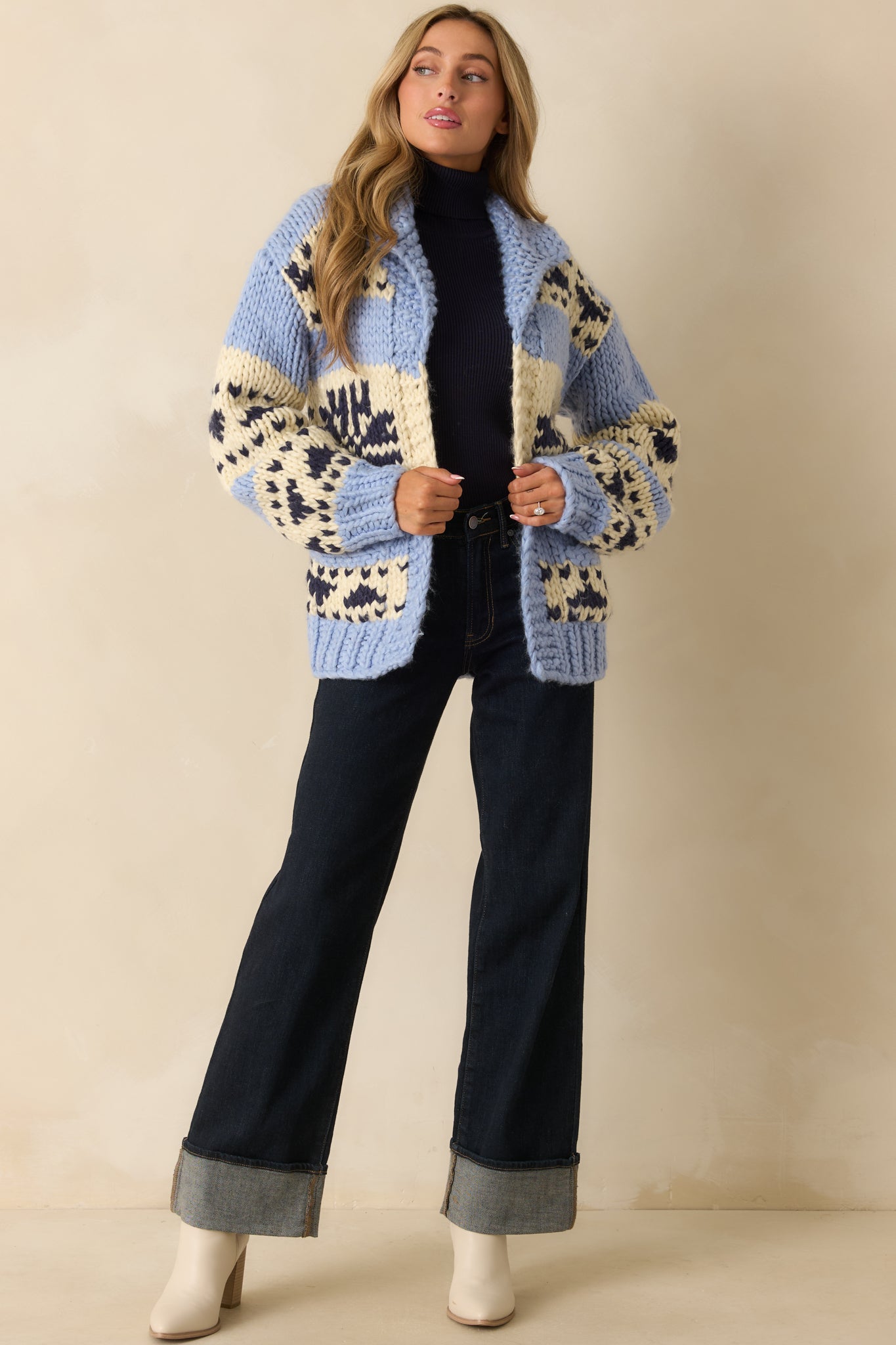 Long-sleeve chunky knit cardigan showcasing open front design, drop shoulders, and bold colorblock pattern.