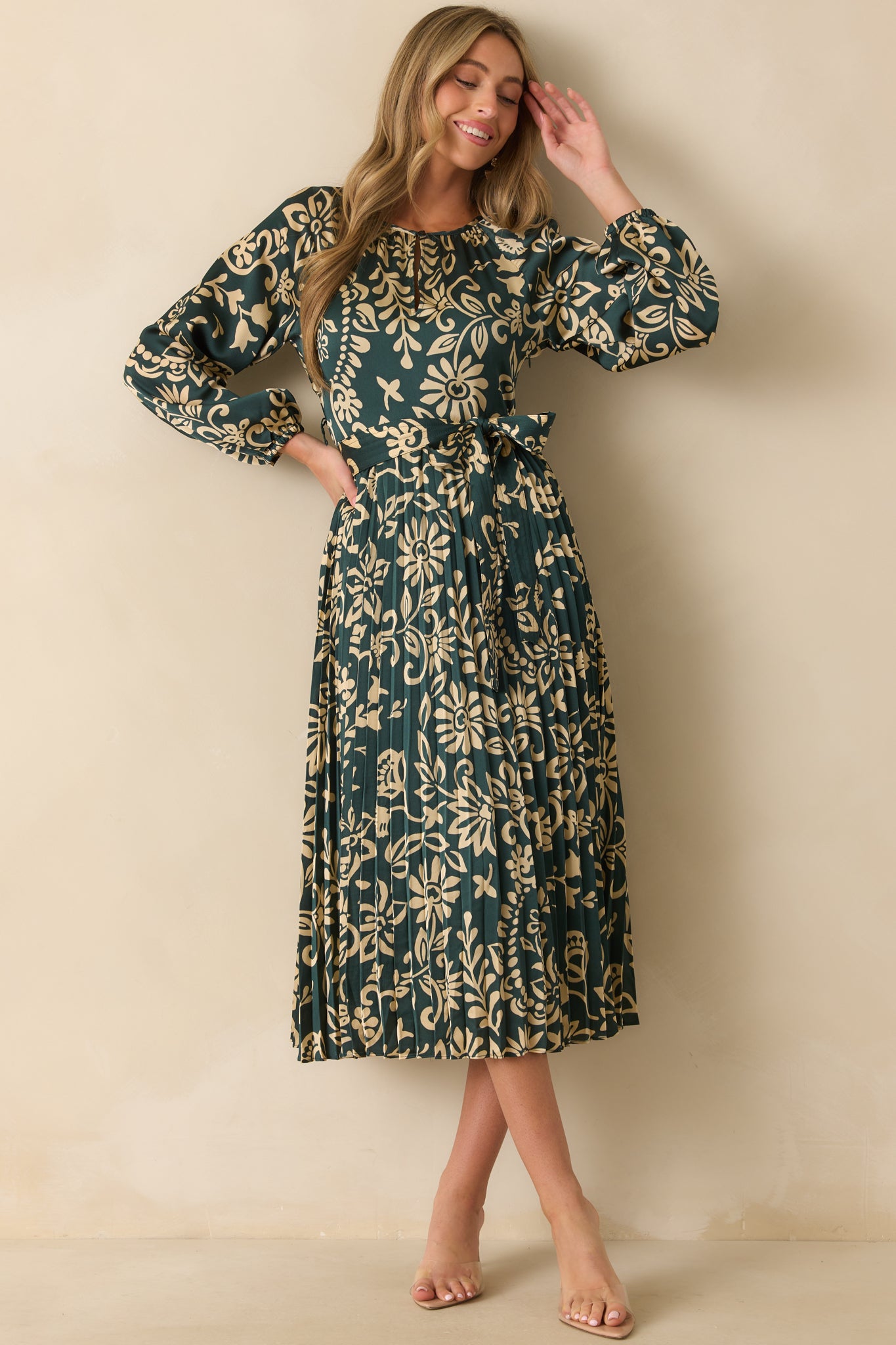 Long-sleeve dress with elastic cuffs and a keyhole button closure at the neckline.