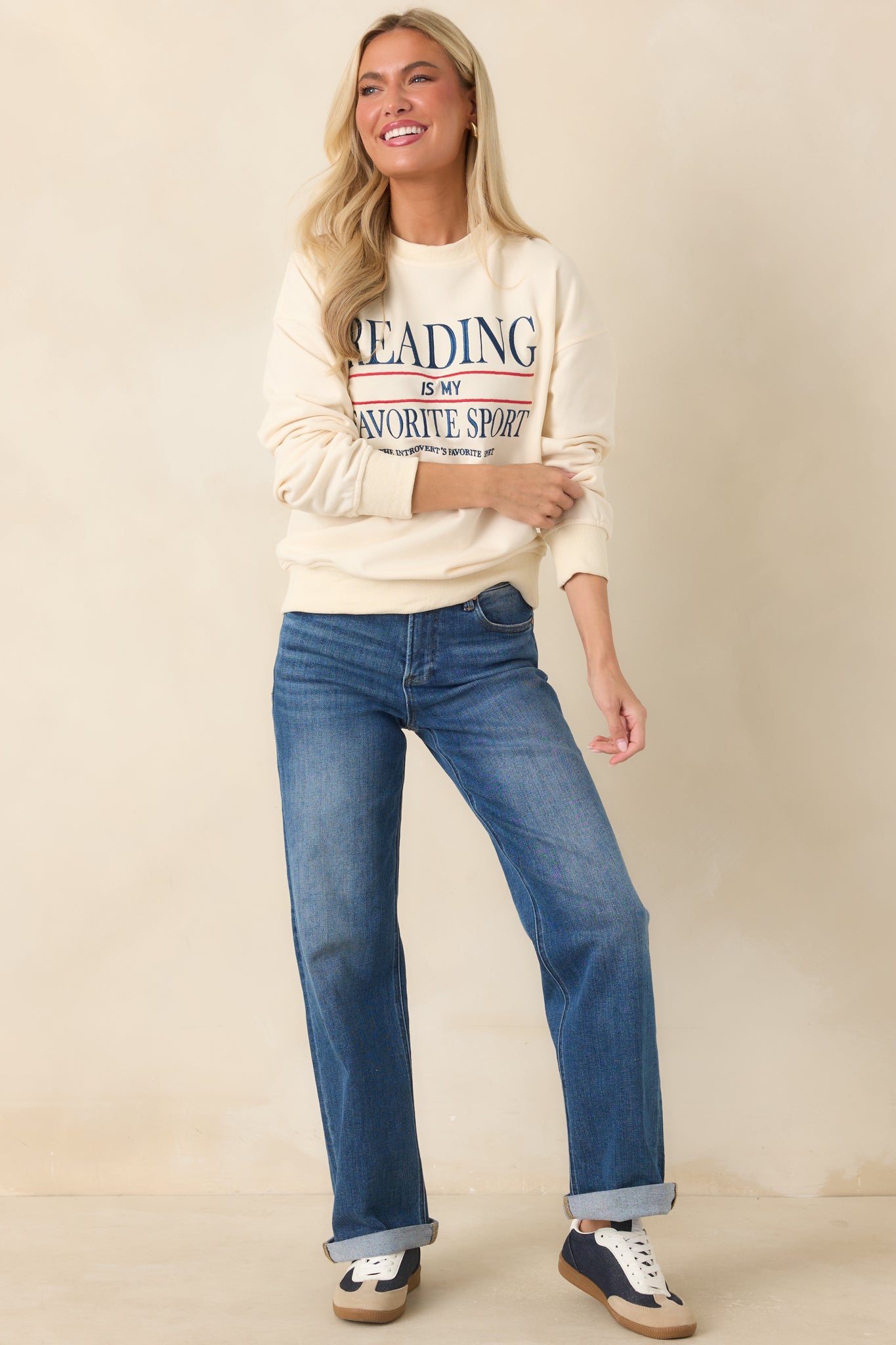 Long sleeve ivory sweatshirt featuring a classic crew neckline and playful embroidered wording on the front.
