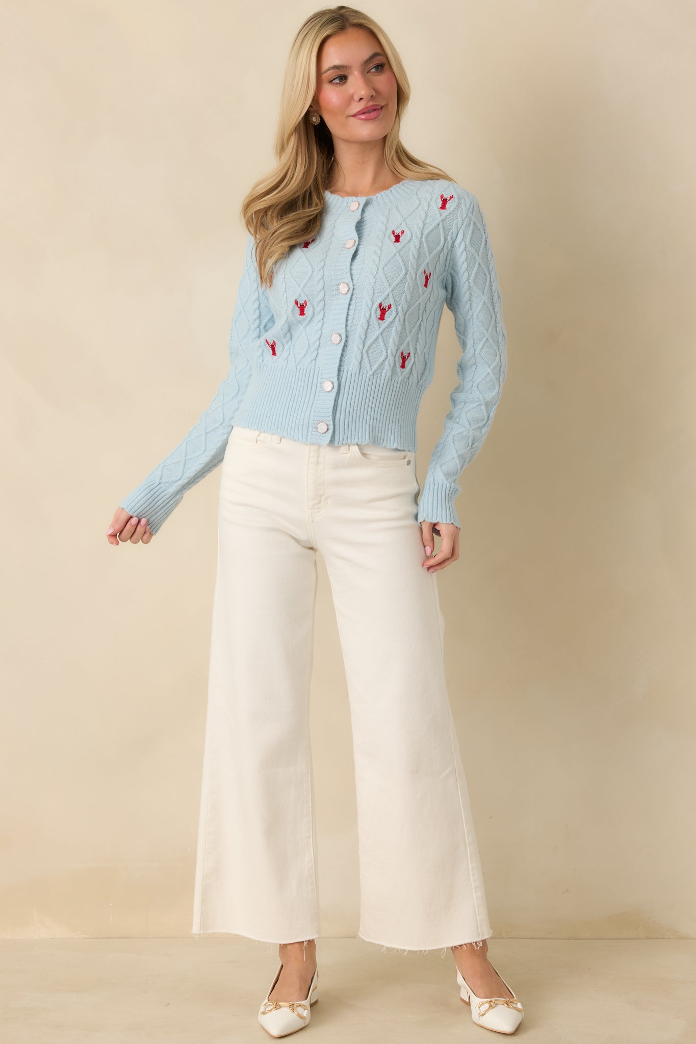 Long-sleeve light blue knit cardigan featuring structured ribbed cuffs and hem for clean lines.