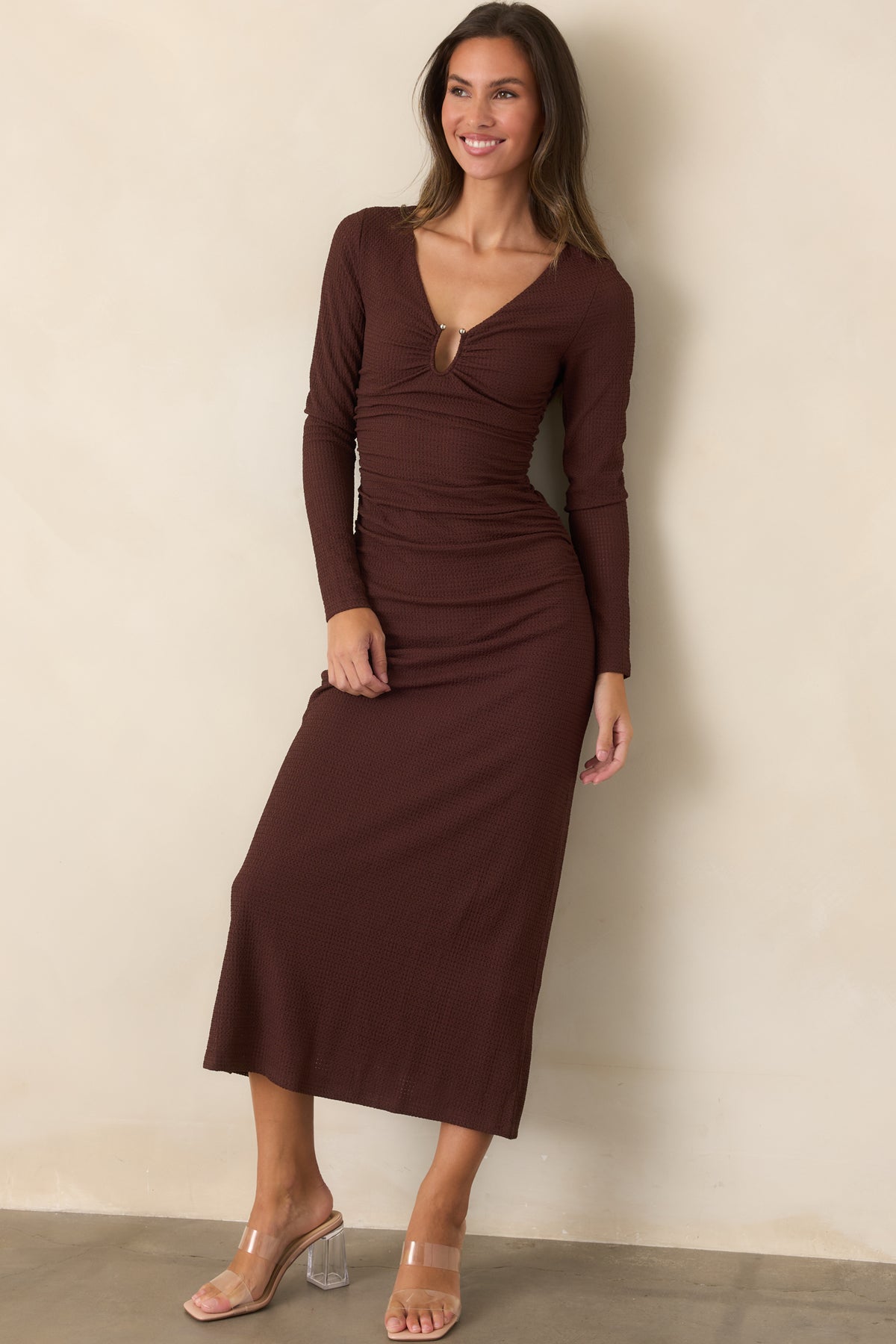 Long-sleeve midi dress features a curve-skimming bodice with gathered detailing and a fluid skirt for an elegant silhouette.
