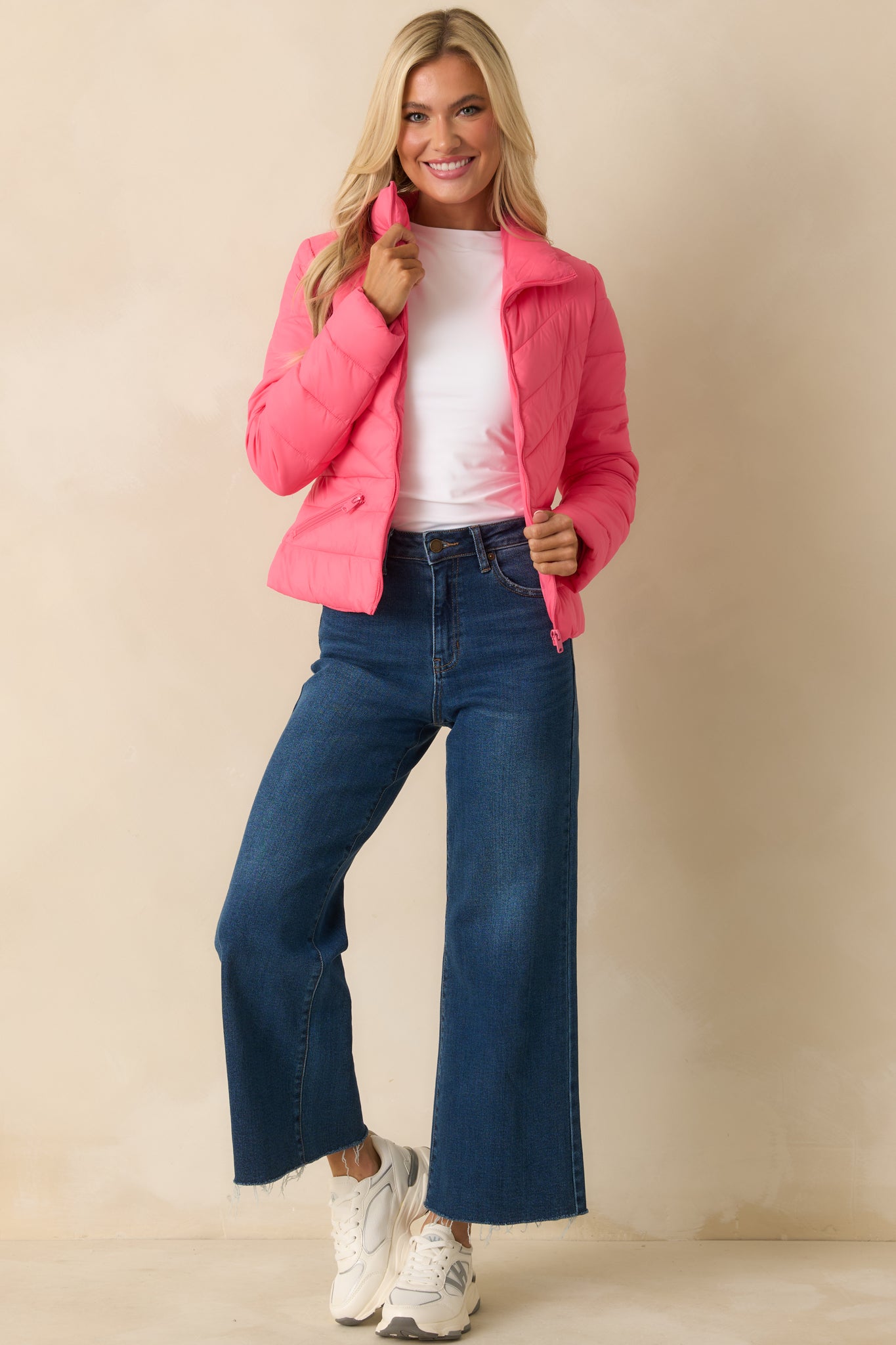 Long-sleeve puffer jacket featuring a zip front closure and zip pockets.