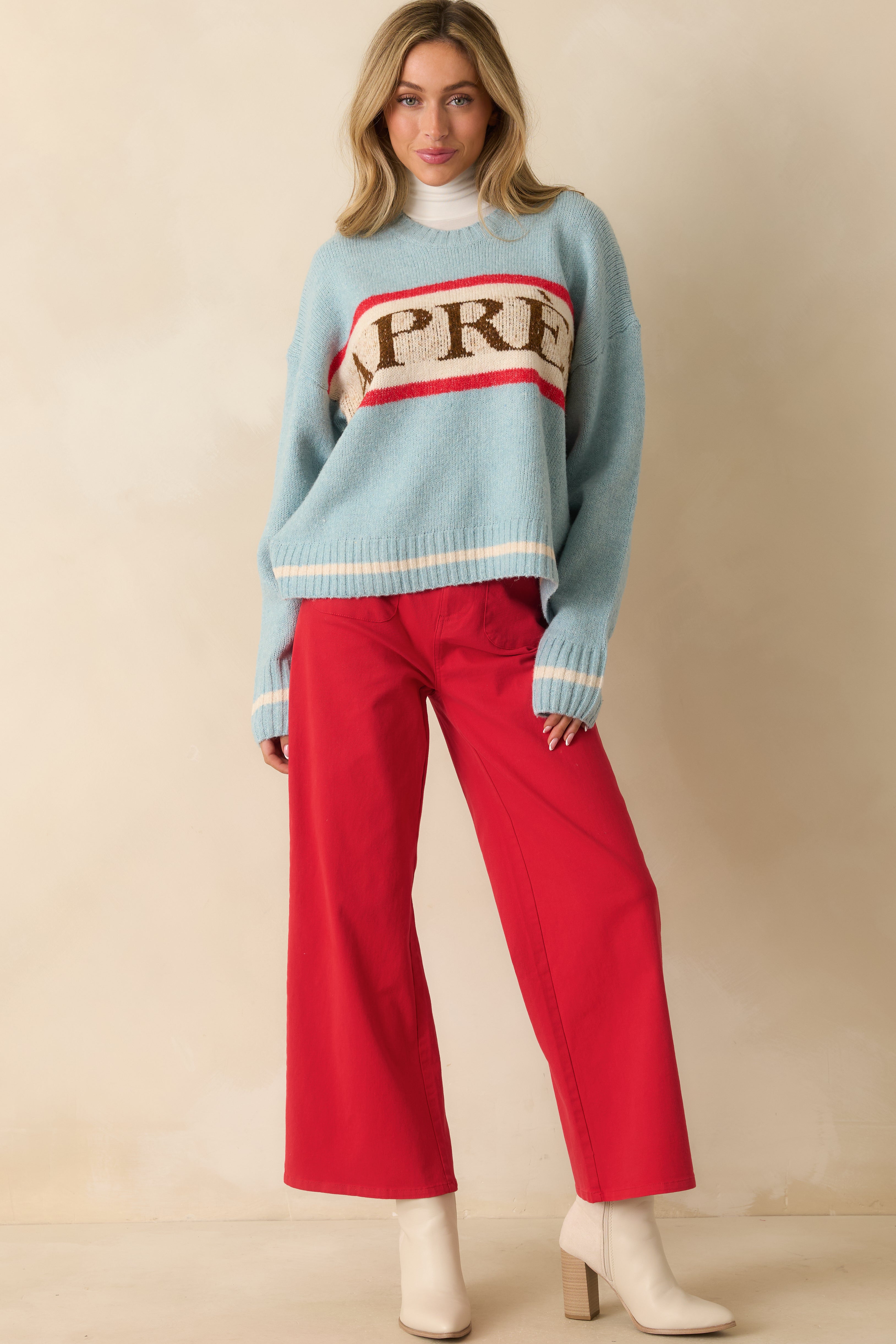 Long-sleeve pullover in soft blue with ribbed cuffs and hem, relaxed fit, and chest stripe accents.