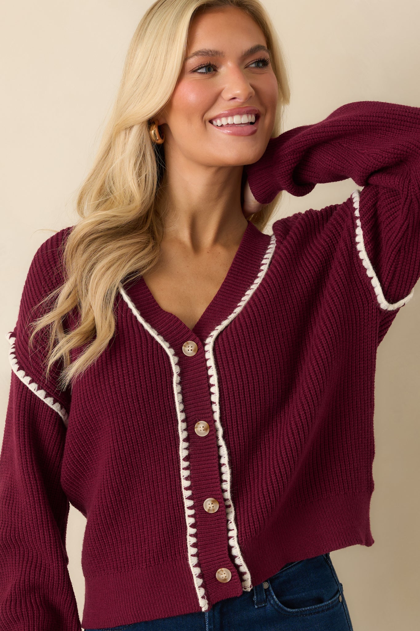 The long sleeve shows the ribbed knit and whipstitch trim running along the cuff for subtle contrast.