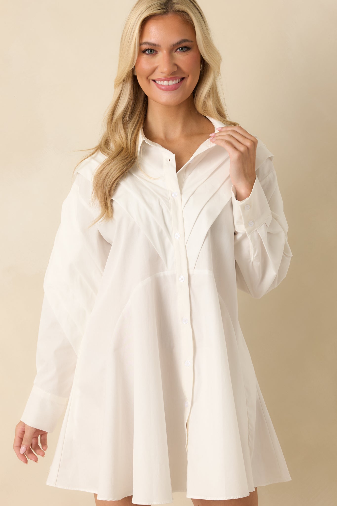 Long sleeve construction with structured pleats along the arms.