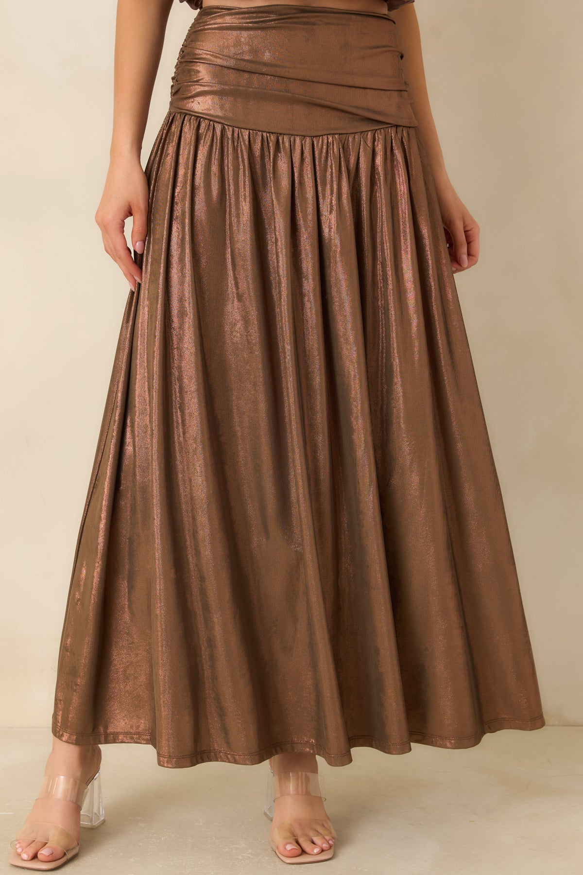 Lustrous bronze fabric falls from the fitted waistband into a full skirt with a coppery sheen.