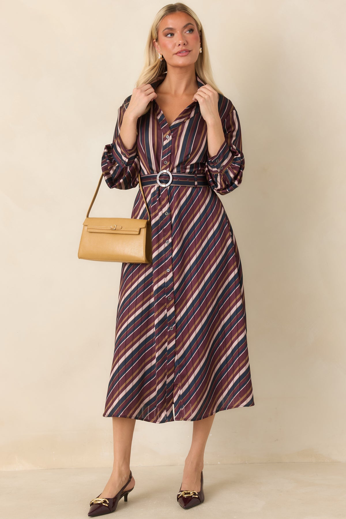 Lustrous satin dress showcasing diagonal stripe placement through the flowing skirt.