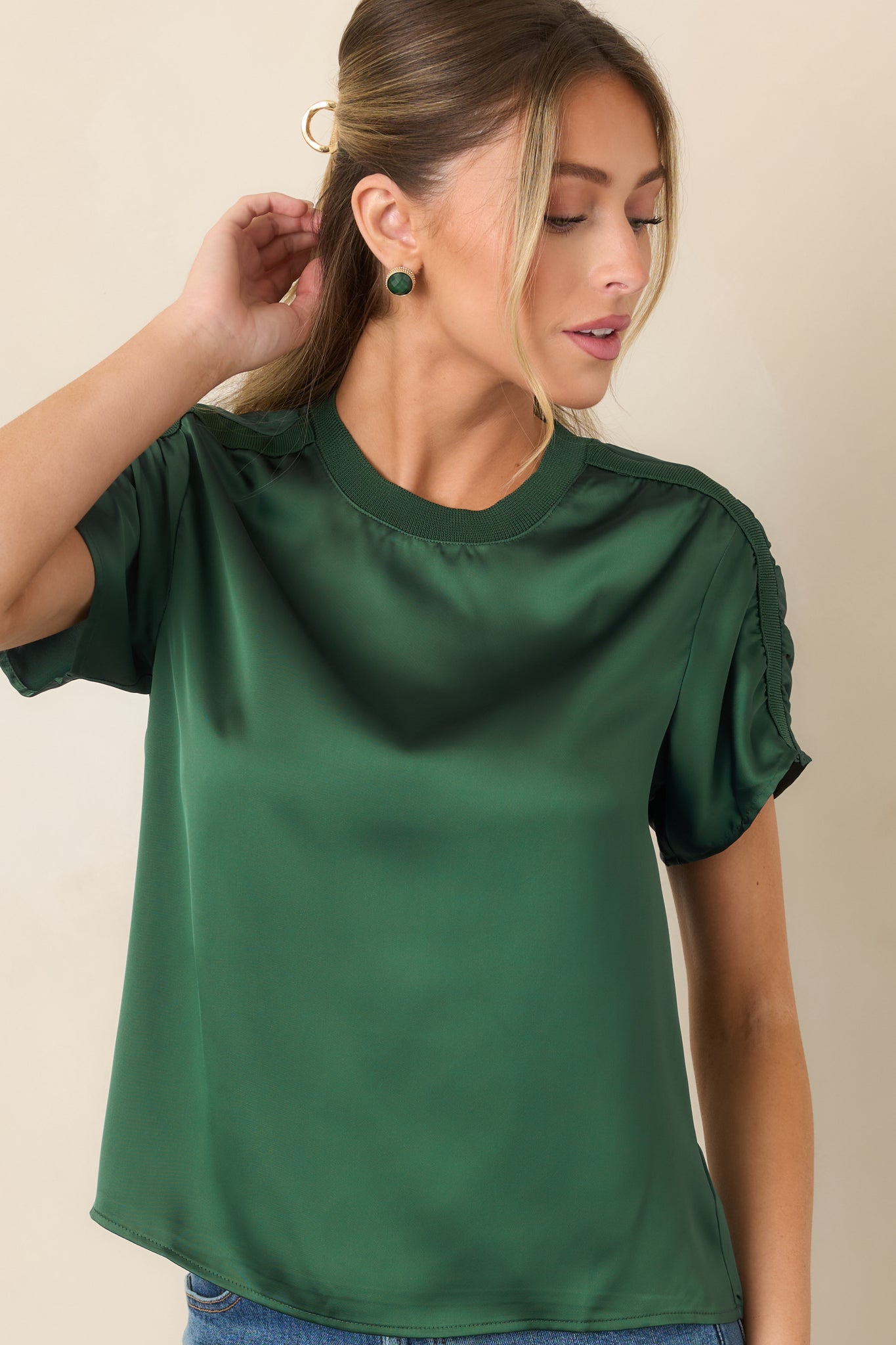 Softly lustrous short-sleeve top highlighting the contrast between smooth satin fabric and textured ribbed trim.
