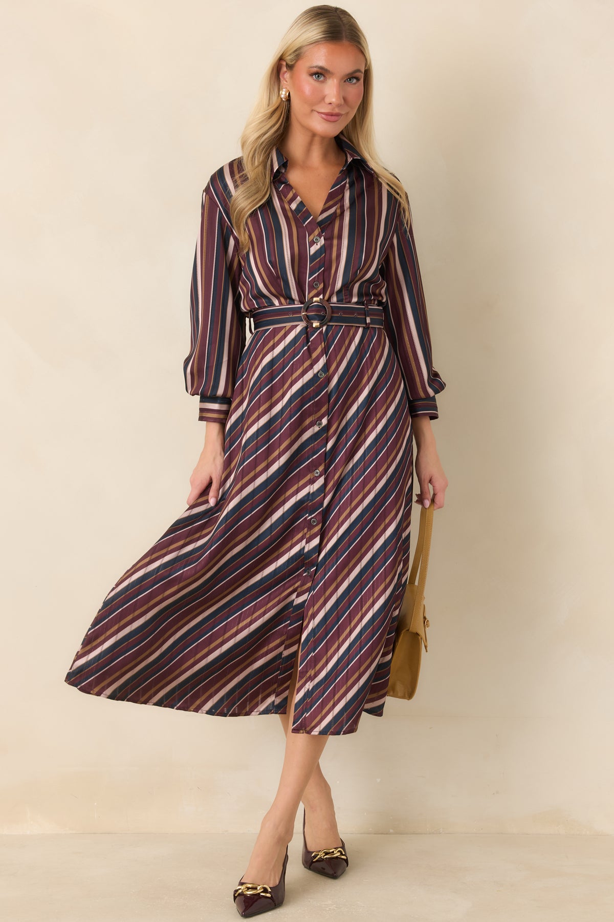 Lustrous striped dress featuring a collared neckline, 3/4 sleeves, and softly defined waist.