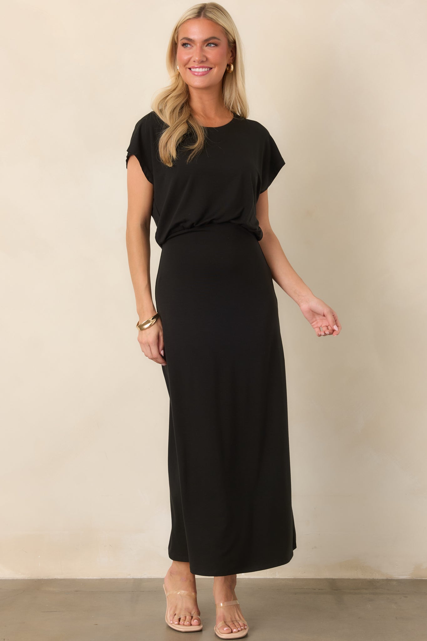 Elegant luxe jersey midi dress featuring a rounded crew neckline, relaxed short sleeves, and a gently gathered blouson silhouette.