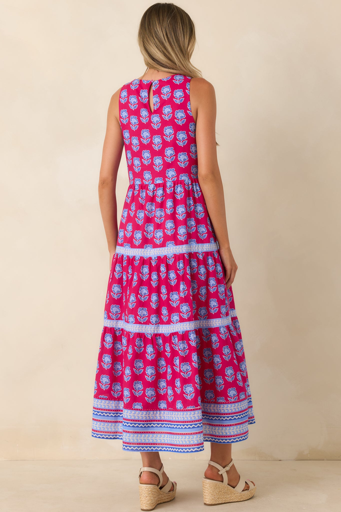 Back of the magenta printed midi dress featuring a keyhole opening with a button closure detail.