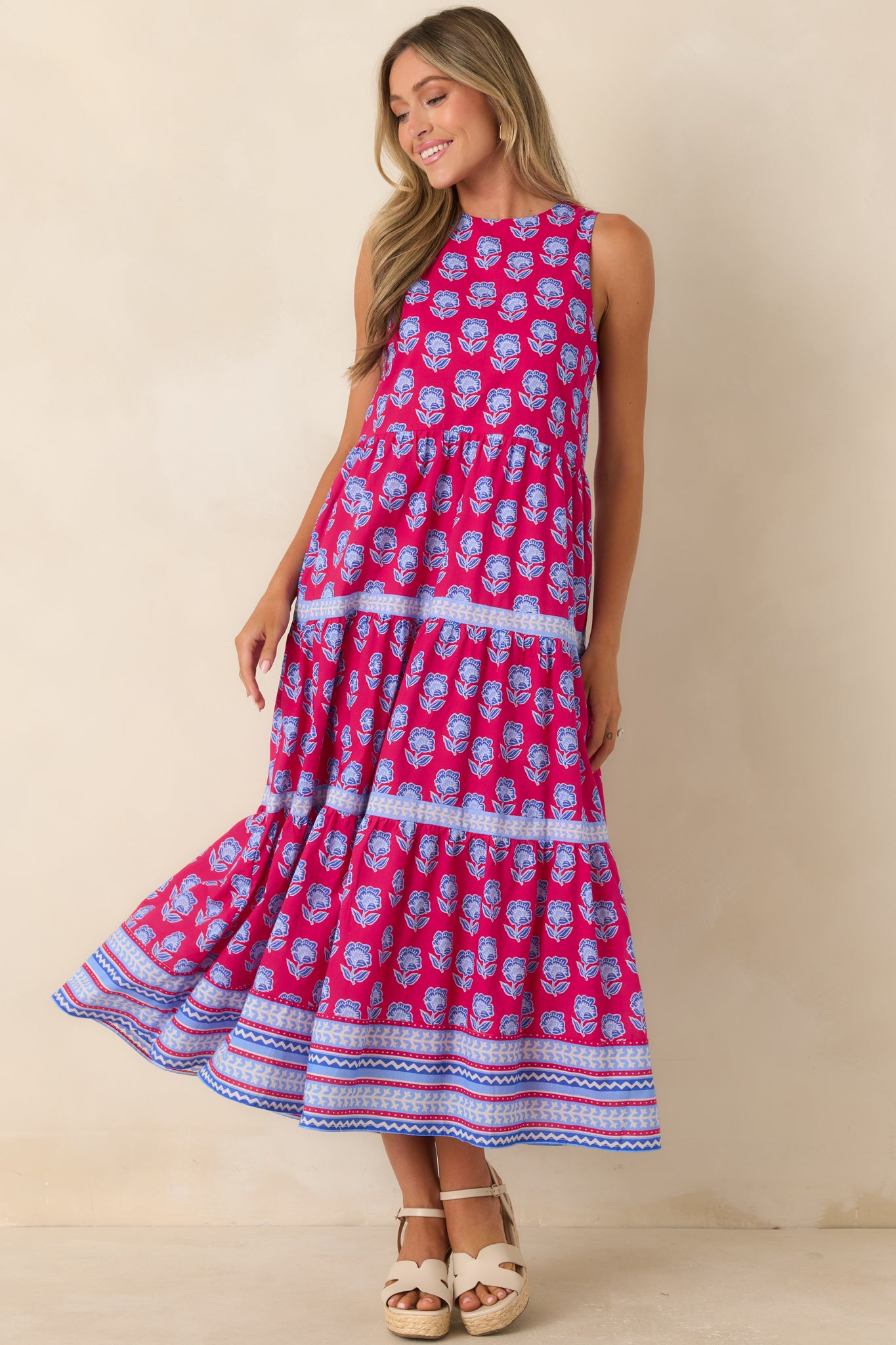 Magenta and blue printed cotton midi dress featuring a sleeveless silhouette, tiered skirt, and floral border trim.