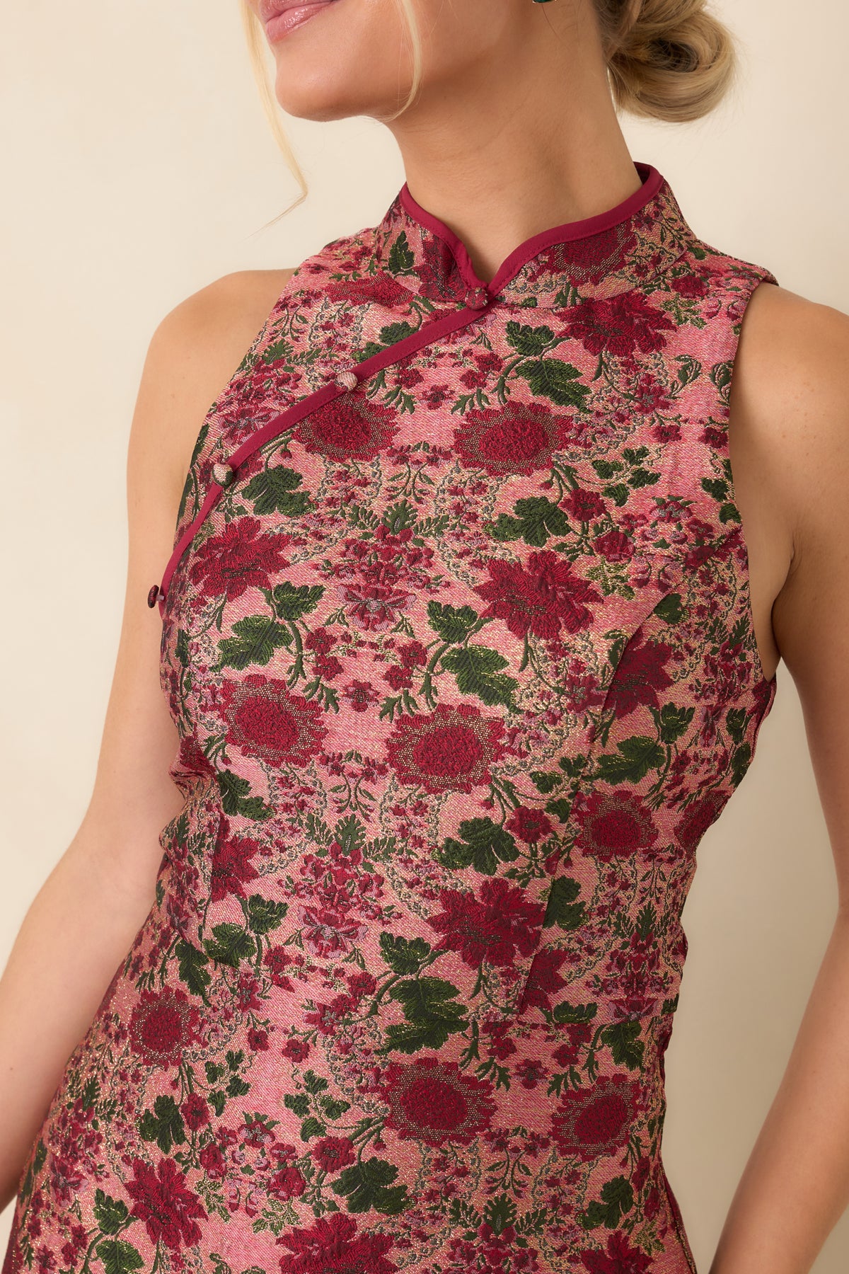 Mandarin collar with burgundy piping, decorative buttons, and diagonal detailing on the rose floral dress.