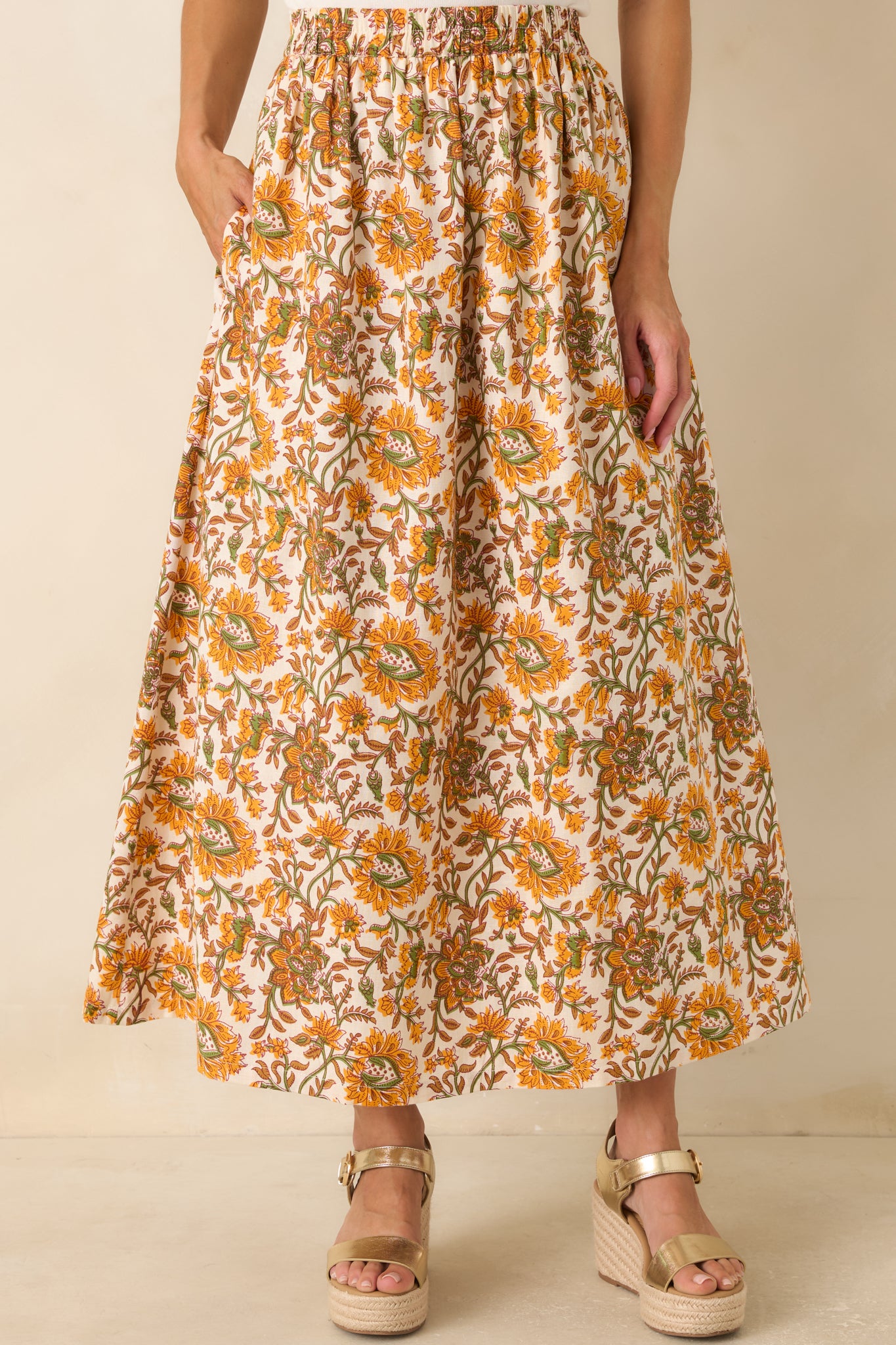 Close view showcasing the marigold and olive floral pattern with the softly gathered elastic waistband.
