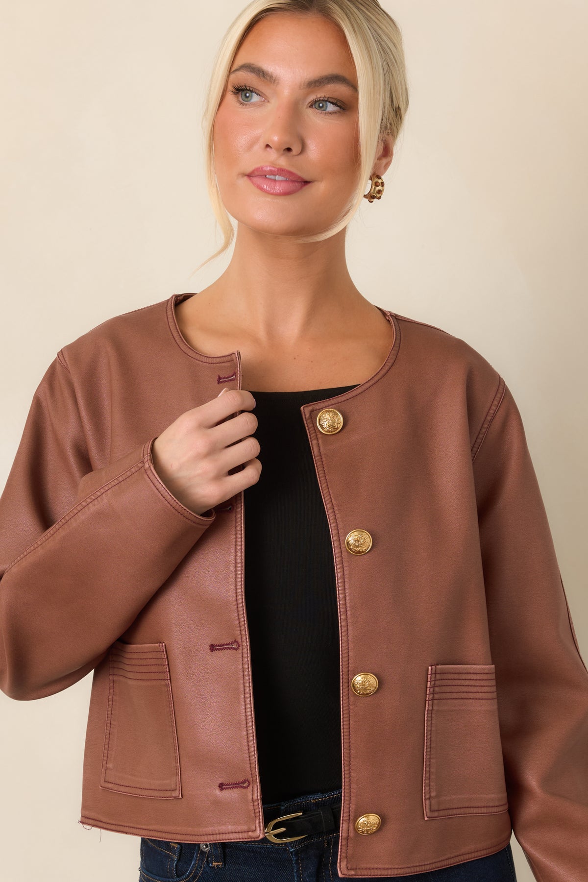 Mauve faux leather jacket featuring functional front welt pockets and long sleeves.