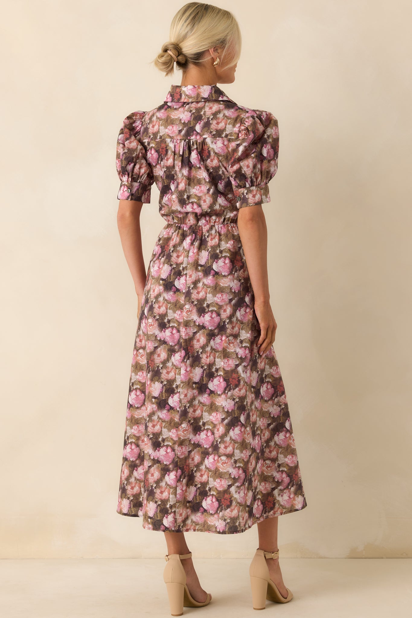 A view from behind showing the mauve floral maxi dress with an elastic waist insert and tie detail at the waist.