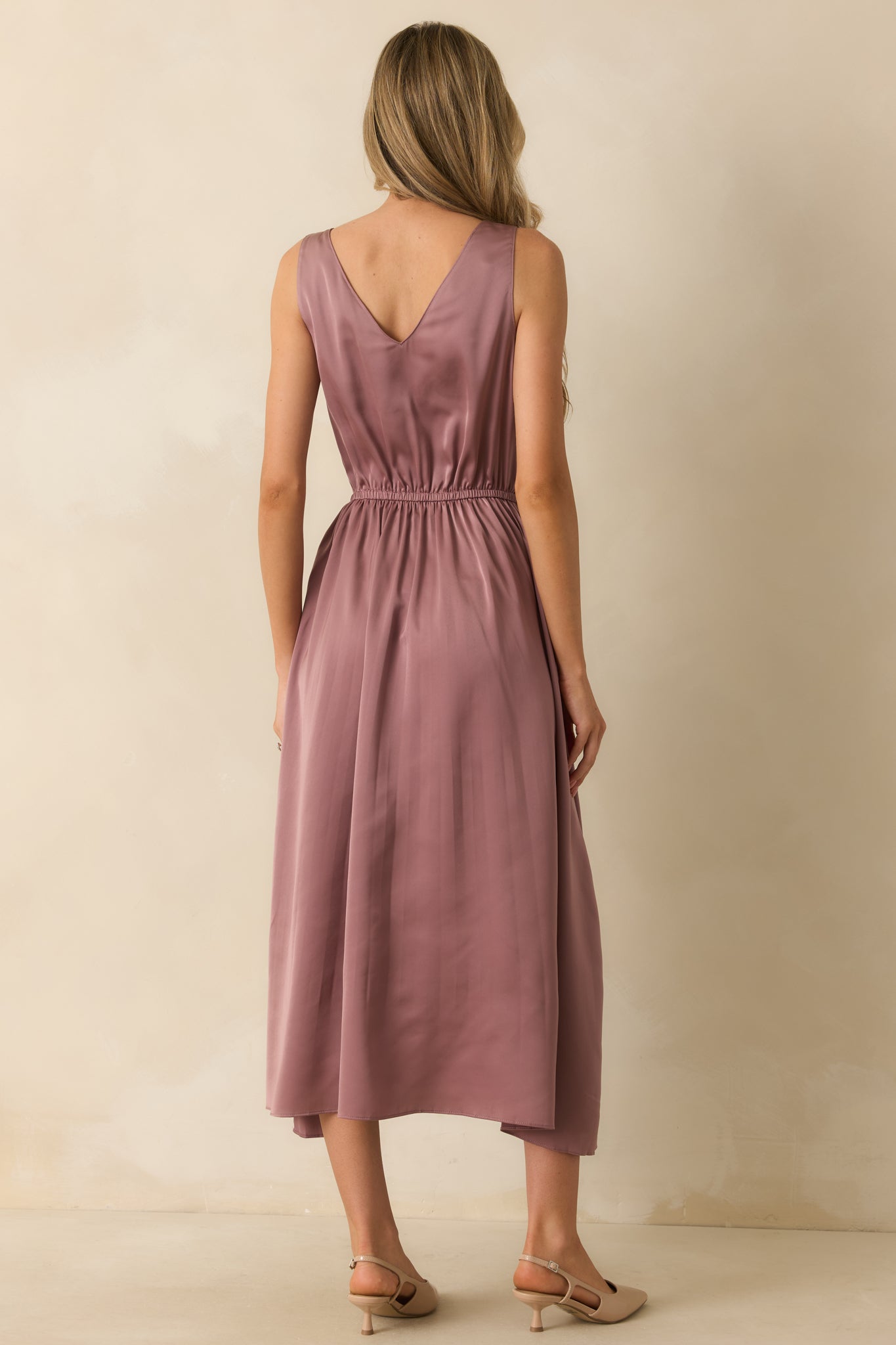 Rear view of the mauve satin dress without the sweater, showing the elastic waist and flowing skirt.