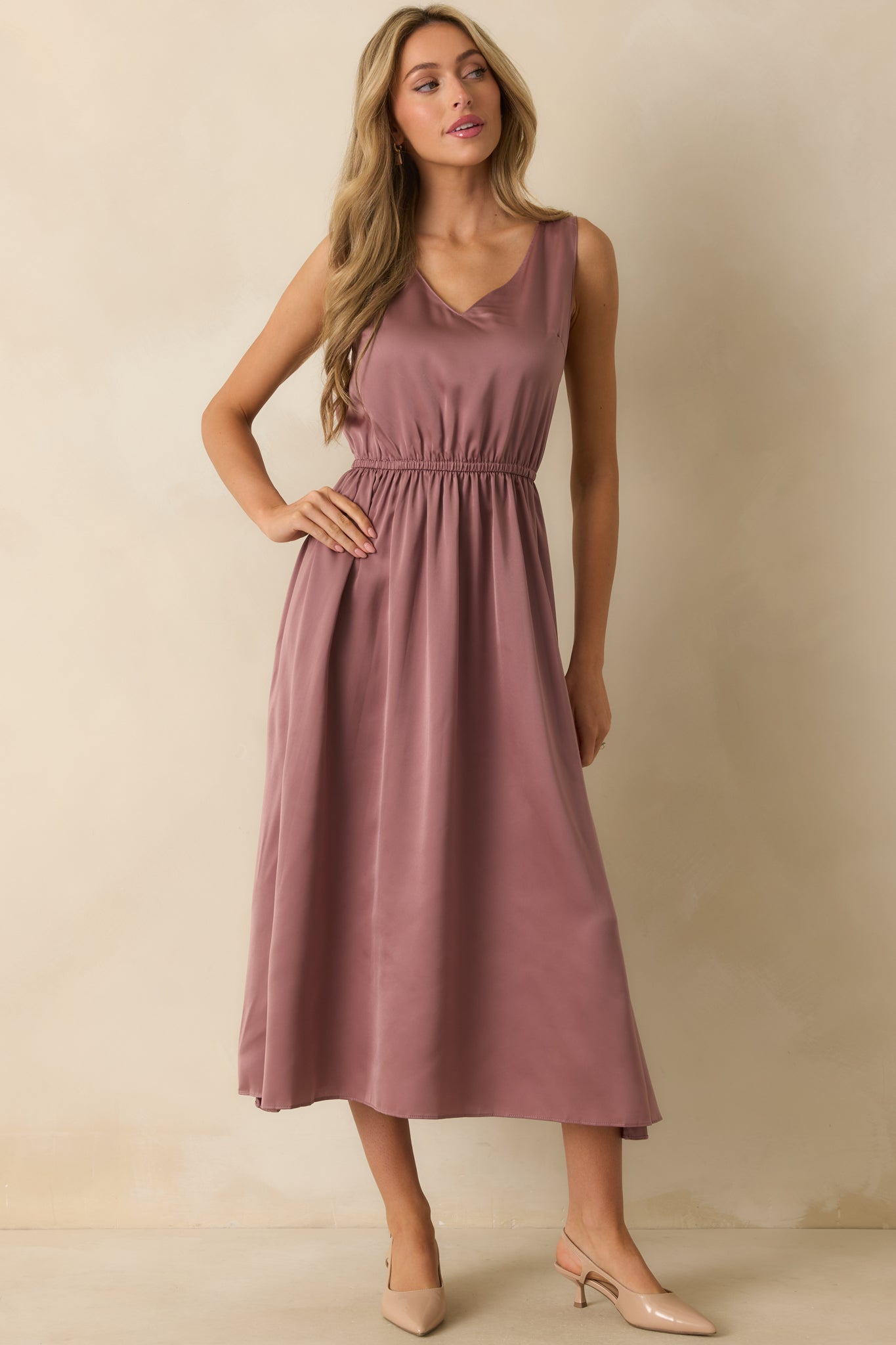Mauve satin maxi dress shown without the sweater, highlighting its v-neckline, elastic waist, and airy drape.