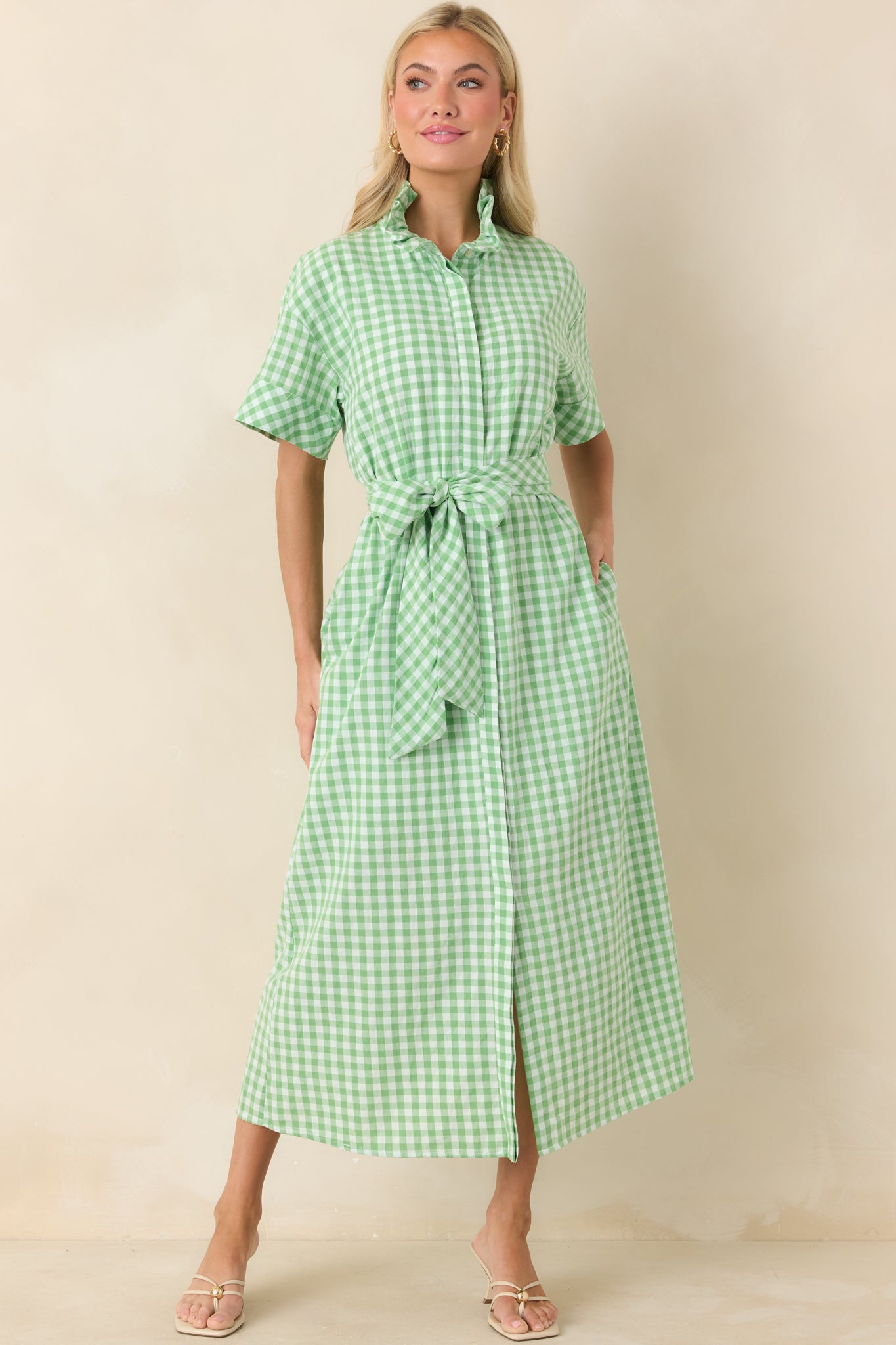 Lightweight gingham maxi dress designed with short sleeves, a ruffled collar, and a fluid silhouette that drapes gracefully to the hem.