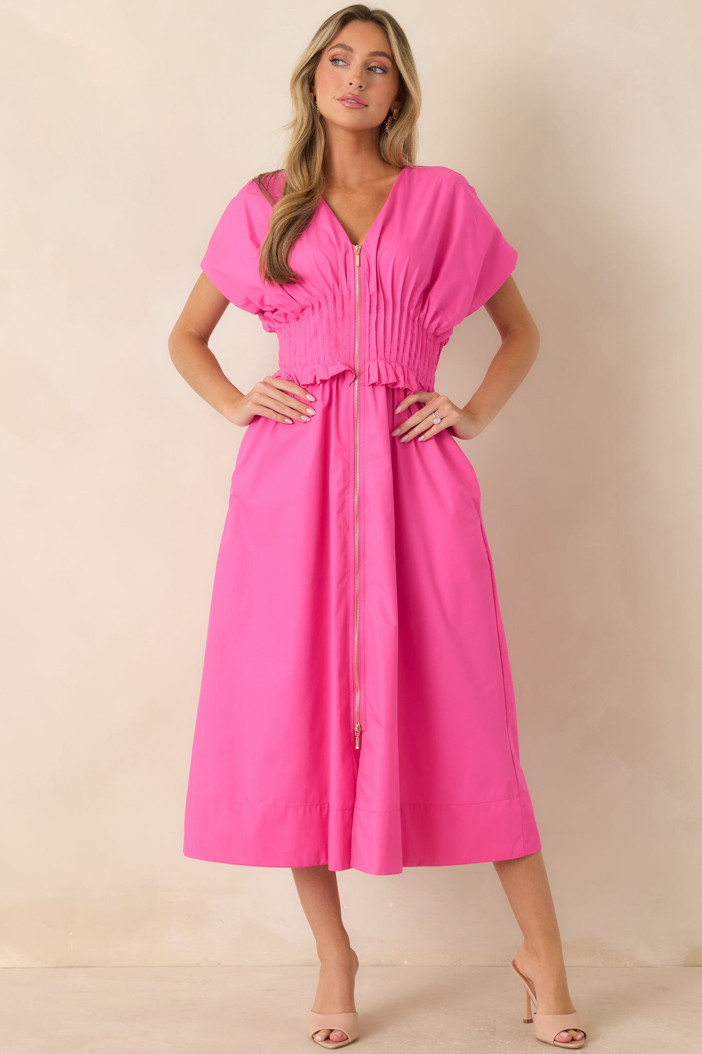 Maxi dress showcasing a front zip detail, ruffled waistband trim, and an easy A-line shape.