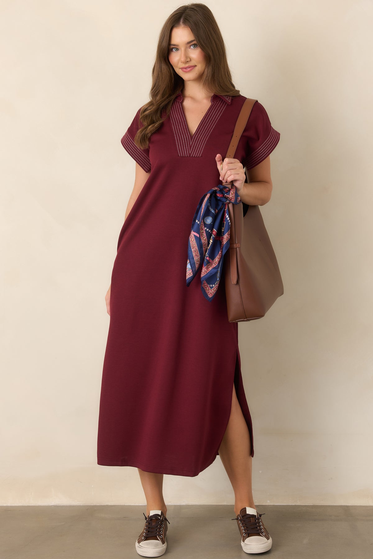 Wine knit maxi dress with crisp pinstriped trim, side slits, and an easy relaxed fit.