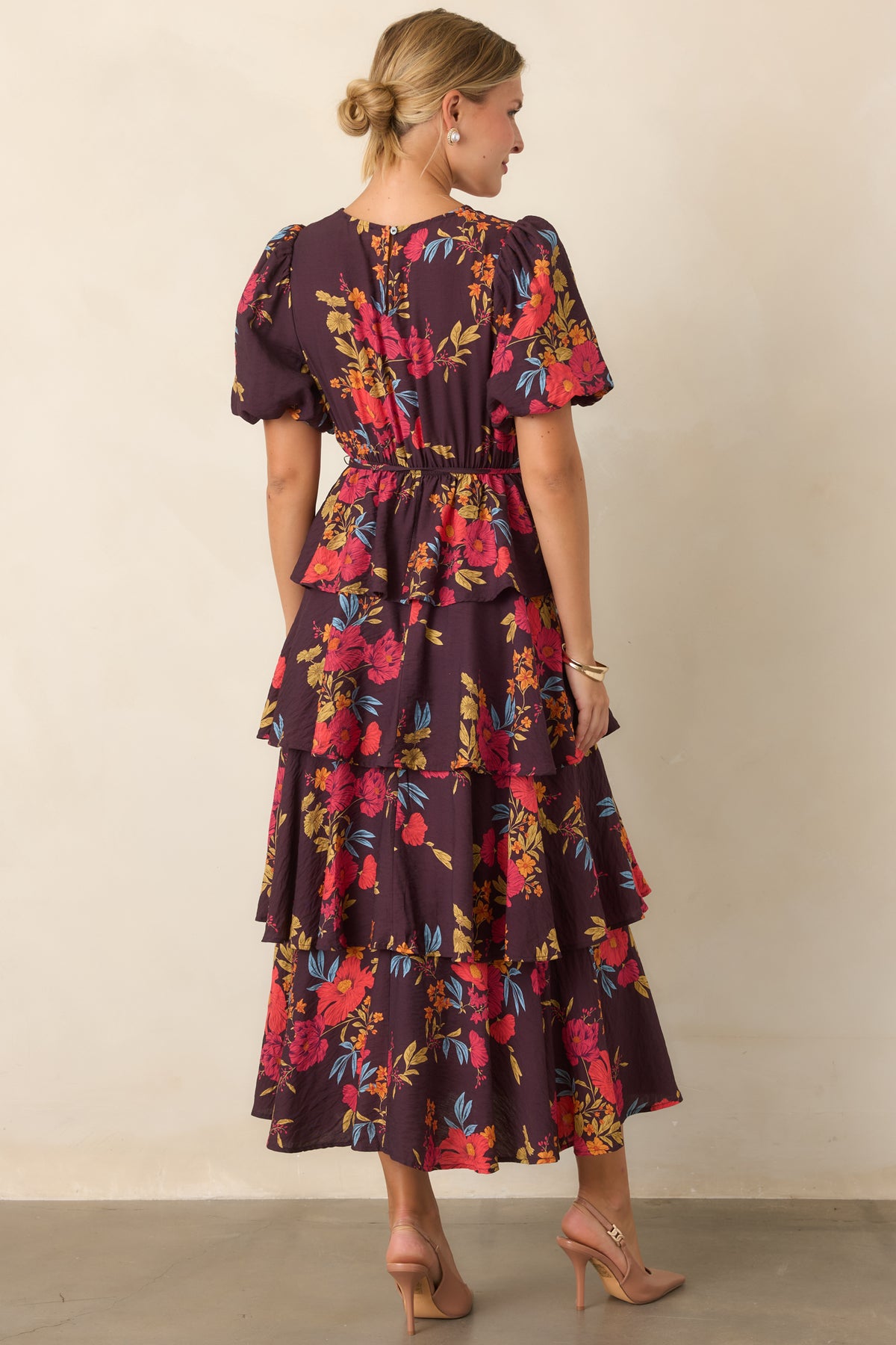 Rear of the maxi dress showing adjustable back ties and the flowing tiered skirt.