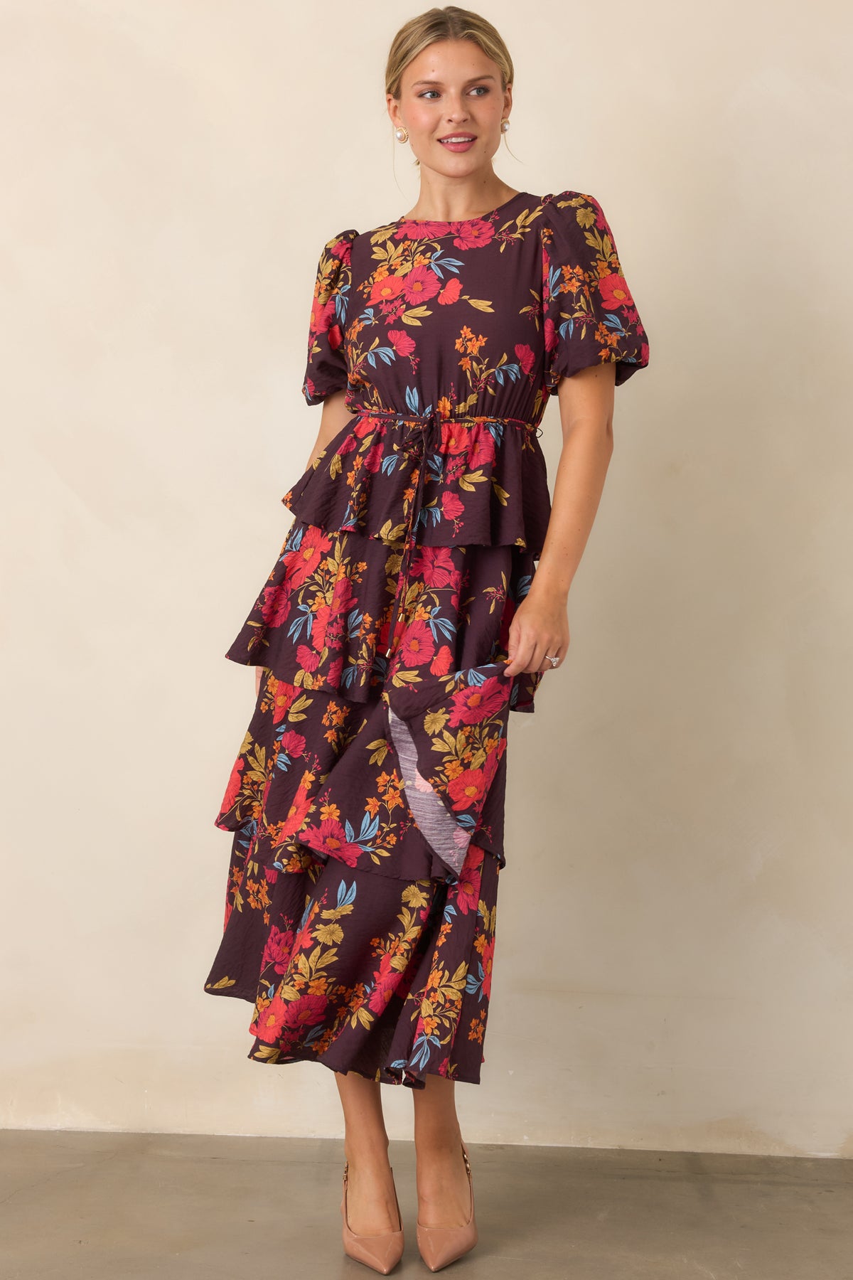 Maxi dress highlighting the tiered A-line skirt, defined elasticized waist, and puff sleeves.