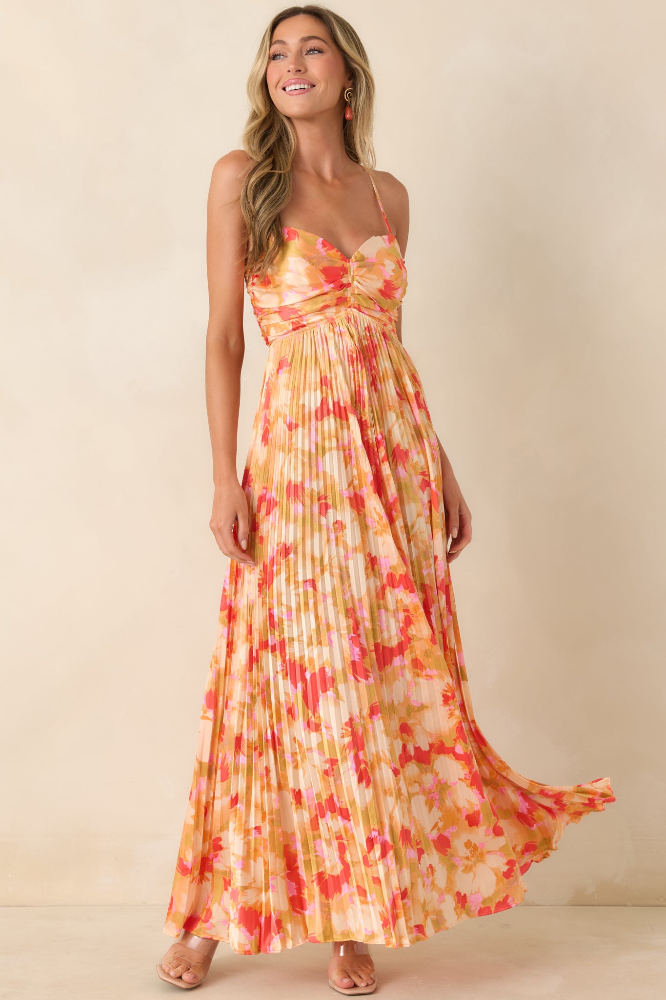 Graceful maxi dress with painterly feel, pleated silhouette, ruched bodice, and adjustable halter-style neckline.