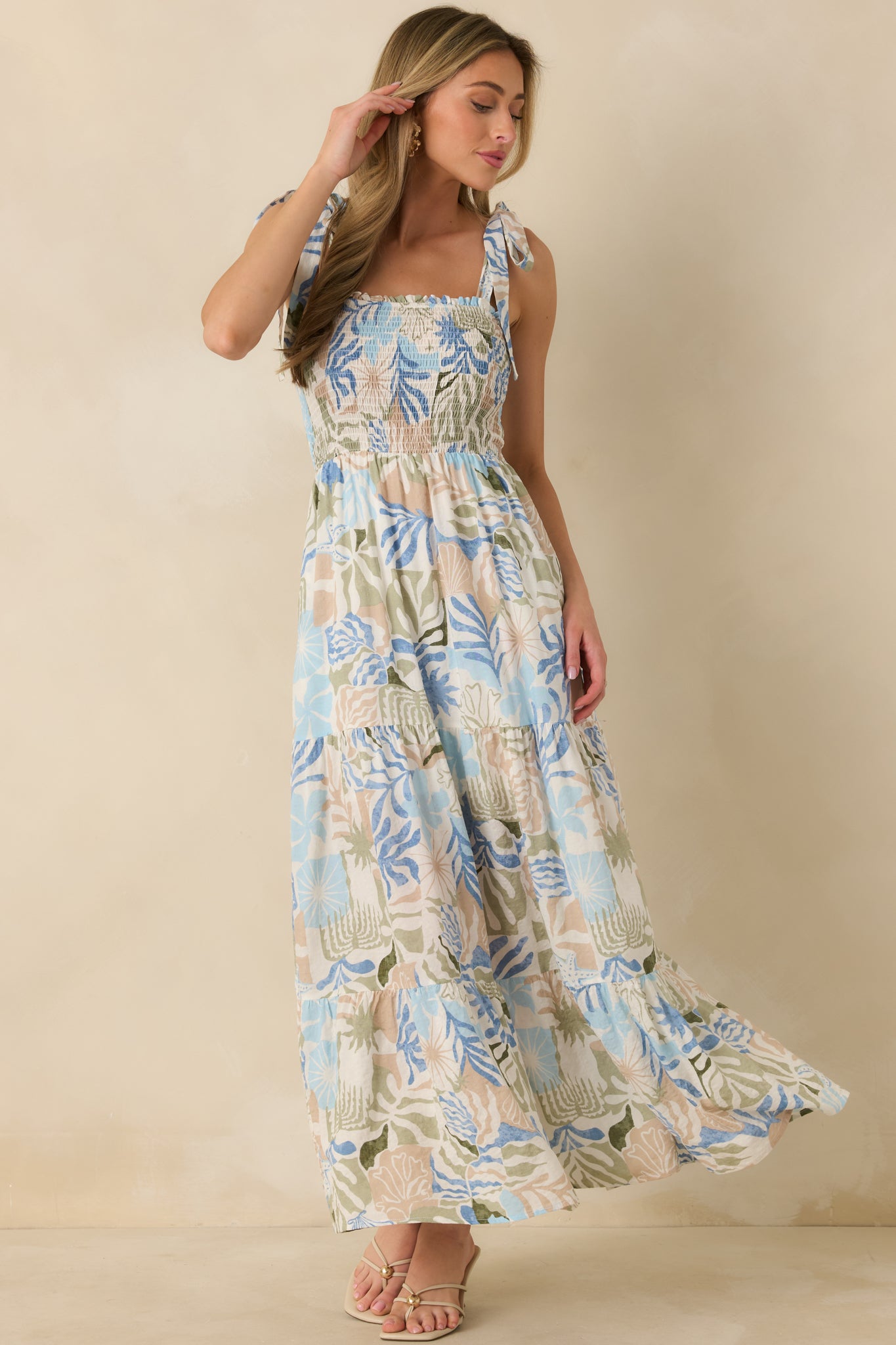 Maxi dress with square neckline, adjustable straps, and smocked top, highlighting the soft movement of the fabric.