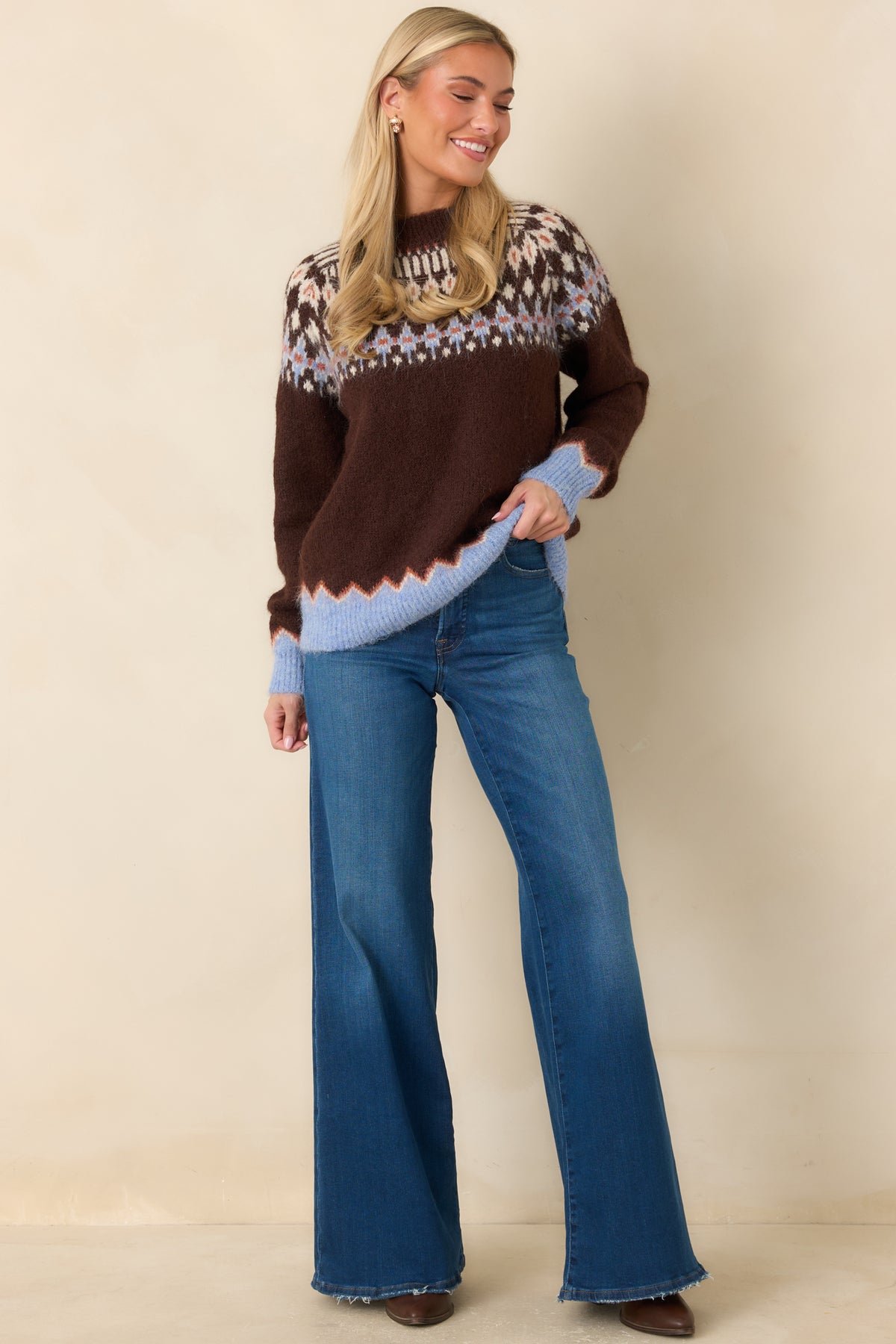 Medium blue high-rise palazzo jeans with a fitted waist, close-fitting hips, and full-length wide legs.