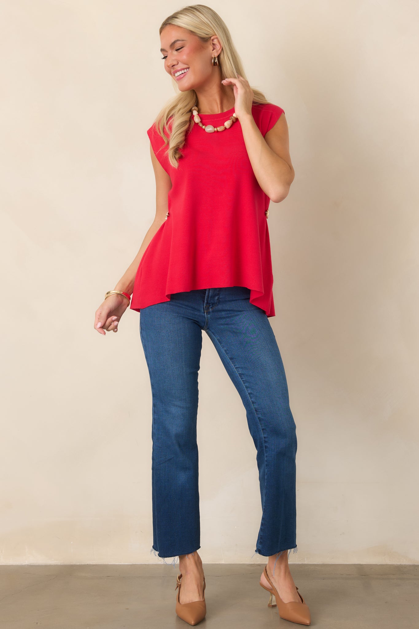 Medium indigo jeans featuring a flattering high-rise waist, slim fit through the hips and thighs, cropped bootcut legs, and raw hems.