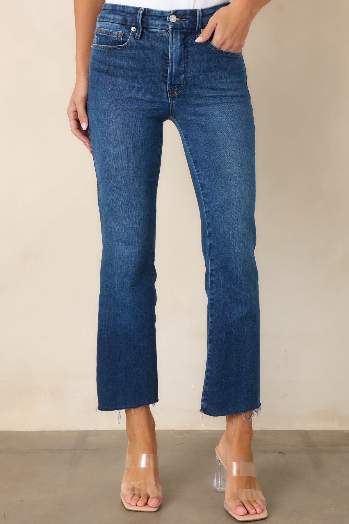 Medium indigo jeans showcasing the high-rise waistband and slim fit through the hips.