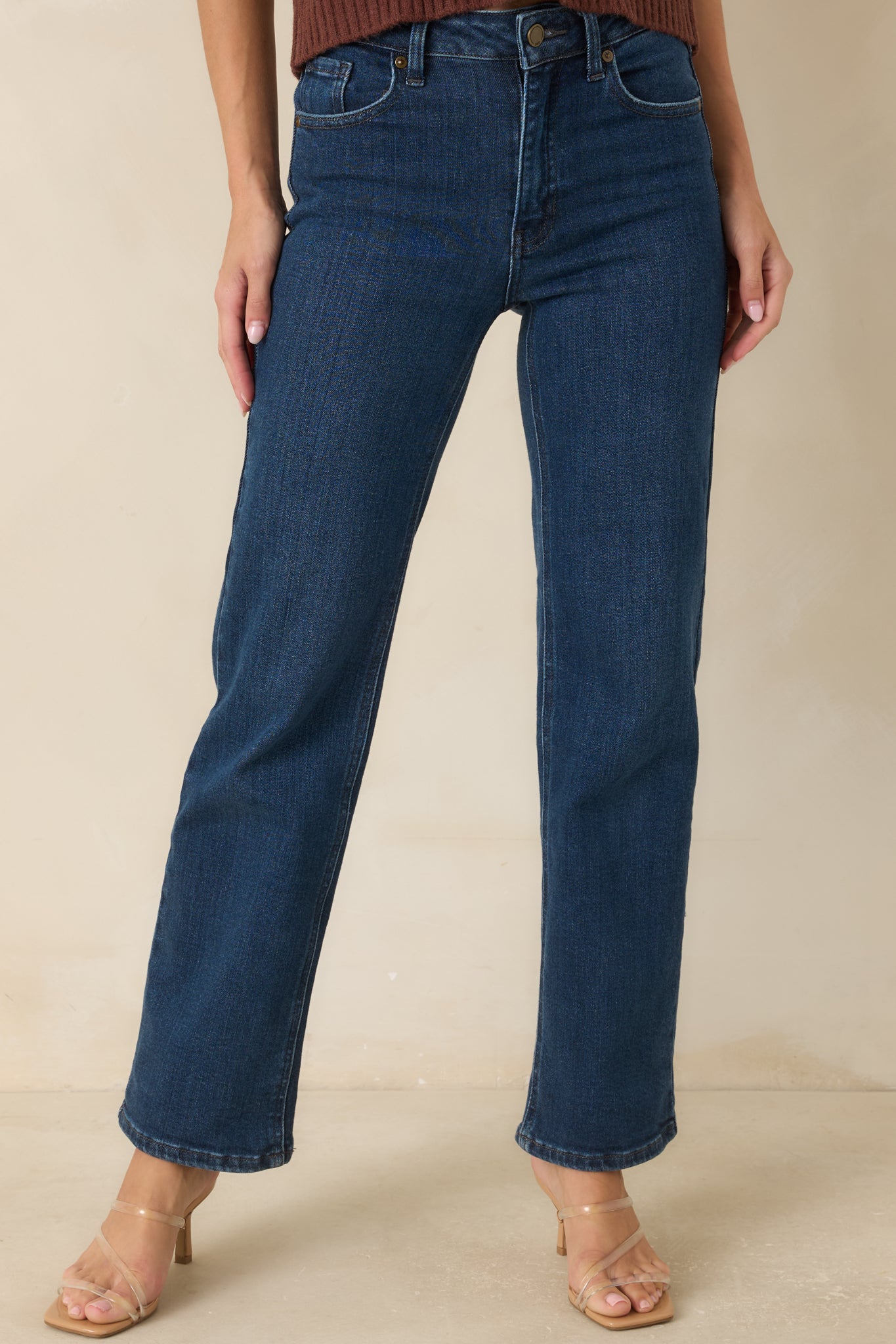 Close view of the medium wash denim highlighting the subtle fading and classic five-pocket styling.