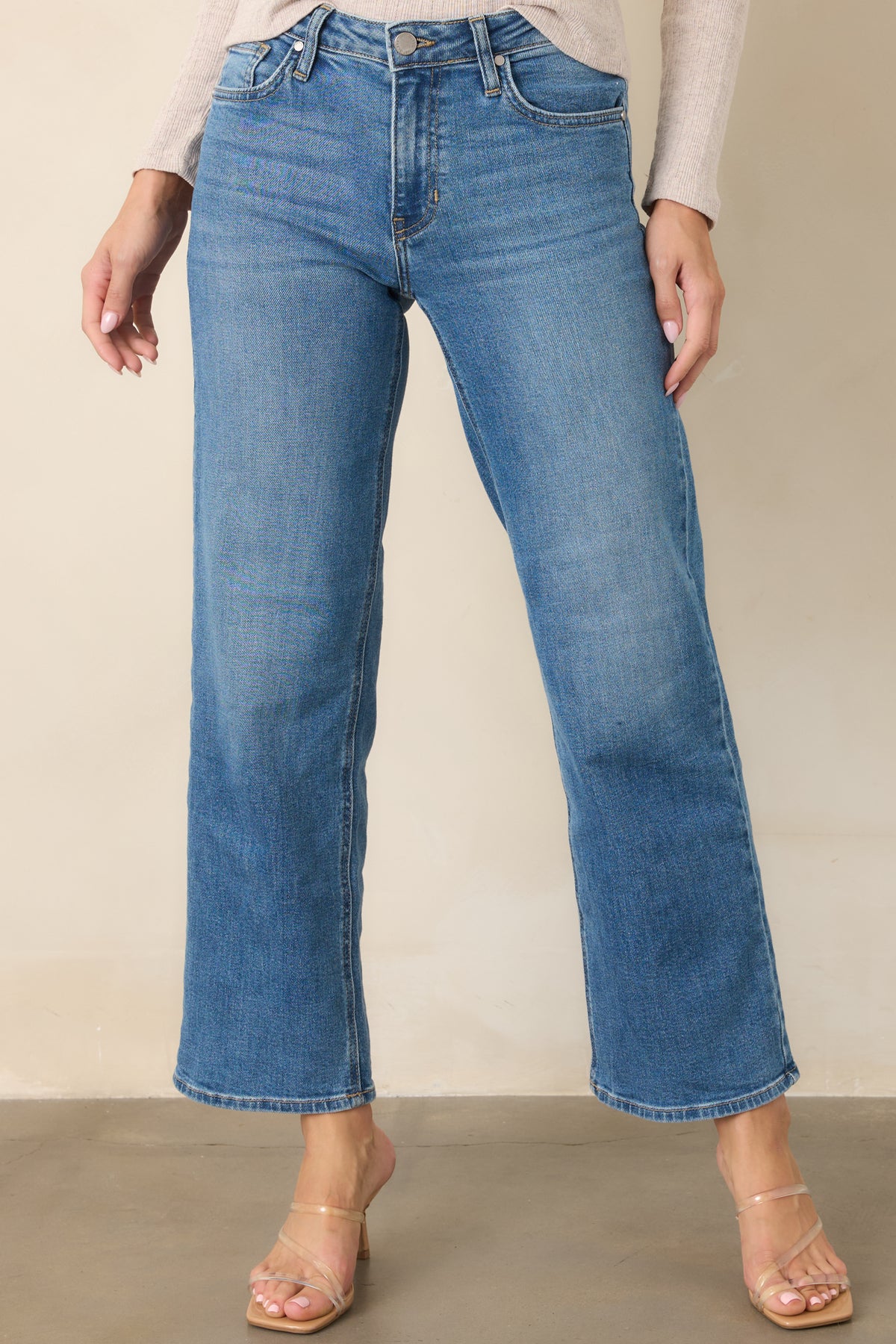Medium wash denim pants featuring classic five-pocket styling and a clean wide-leg silhouette.