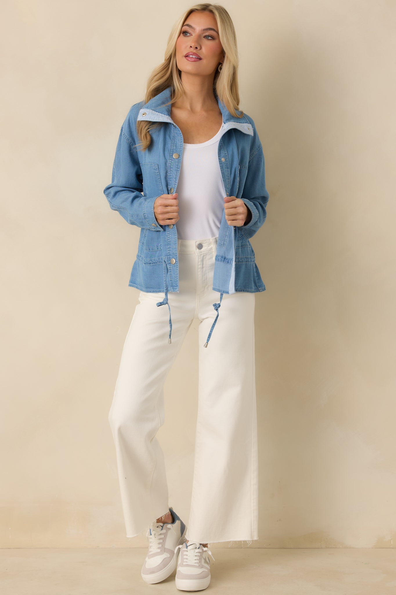 Medium wash lightweight denim top with silver-tone snap front, classic collar, and adjustable drawstring waist.